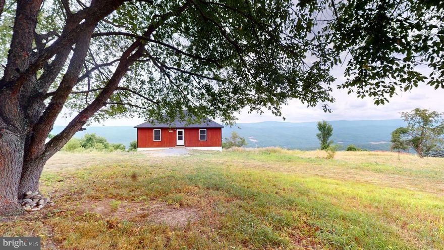 IT'S ALL ABOUT THE VIEW!  The song, On Top of the World Looking Down on Creation could have been written from this spot on top of Romney Mountain!   Wind your way up the WV mountain to the cabin with the view.  This 2 bedroom 1 bath home has all one needs for full time living or that perfect get away.   The location offers lots of wildlife and the peace and quiet John Denver sung about.  There is also a full unfinished basement with a roughed in bath waiting for you to complete.  Need more room for family or a game room?  This could be that perfect spot.  The newly built back deck offers The sunrise and the views of the surrounding mountains and the valley below.  Look off to the left and you can see the historic town of Romney.  Just a short distance before climbing the mountain is a public river access to the South Branch of the Potomac River which provides fishing, floating, canoeing and so much more.  Also in the area is the Potomac Eagle excursion train,  Civil War Trenches,  Dr. offices, Restaurants, Hospital, WV's Home of the Deaf and the Blind School,  The surrounding towns  include Walmarts and additional shopping.  Cumberland Md and Winchester VA are about an hour away.  DC metro is about 2 hours making this a great get-away.