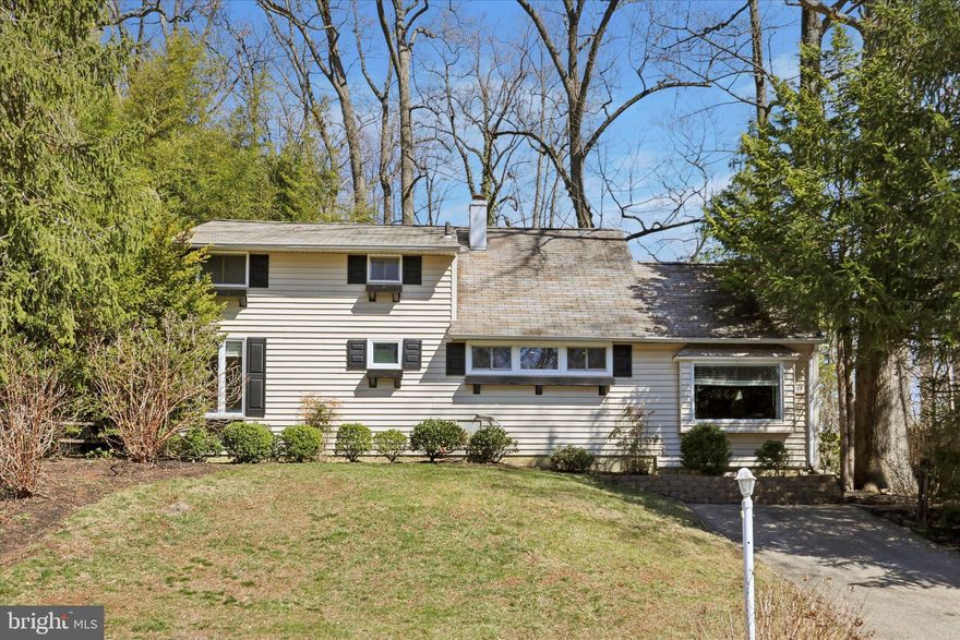 Welcome to 13 Devonwood Road, a 3-bedroom, 2-bathroom home in an unbeatable Wayne location that is awaiting your personal touches! Step inside to a spacious foyer that doubles as a cozy den, complete with built-in storage, hardwood floors, and a wood-burning fireplace. Just a step up, the large dining room seamlessly connects to the expansive family room, where vaulted ceilings, another wood-burning fireplace, and backyard access create a bright and airy gathering space. The kitchen, featuring white cabinetry, granite countertops, and stainless steel appliances. The main-floor primary bedroom serves as a private retreat, offering a sliding door to its own patio—ideal for morning coffee or evening unwinding. A first-floor office provides flexibility for work or study. Upstairs, two additional bedrooms and a full bath complete the home.  Outside, the true highlight awaits—an expansive backyard with both a deck and patio, perfect for entertaining or simply enjoying the peaceful surroundings. Situated in a fantastic location, this home is within walking distance to parks, downtown Wayne’s vibrant shops and dining, and is in the award-winning Radnor Township School District. Don't miss this incredible opportunity to enjoy the best of Wayne—schedule your showing today!