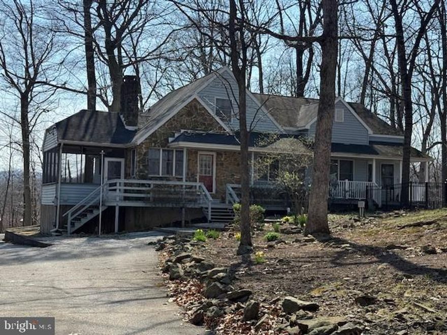 Tucked away in a peaceful setting, this unique home offers two  living areas, making it ideal for out-of-town guests.  Thoughtfully designed, the home features two kitchens, two laundry rooms, two heat pumps and two wood burning fireplaces, providing comfort and independence for all.  Hardwood floors, 3 full baths, a spacious layout, and abundant closets and storage throughout.  A large den, and loft area provide excellent options for a home office, media room,  or creative space.  
 Multiple decks invite outdoor entertaining, while the cozy screened-in porch is perfect for relaxing and enjoying the tranquil surroundings.
Pet lovers will appreciate the fenced area, creating a safe and secure space for pets to play.  With its versatile layout,  peaceful setting, and exceptional functionality, this home truly offers something special for today's flexible  living needs.