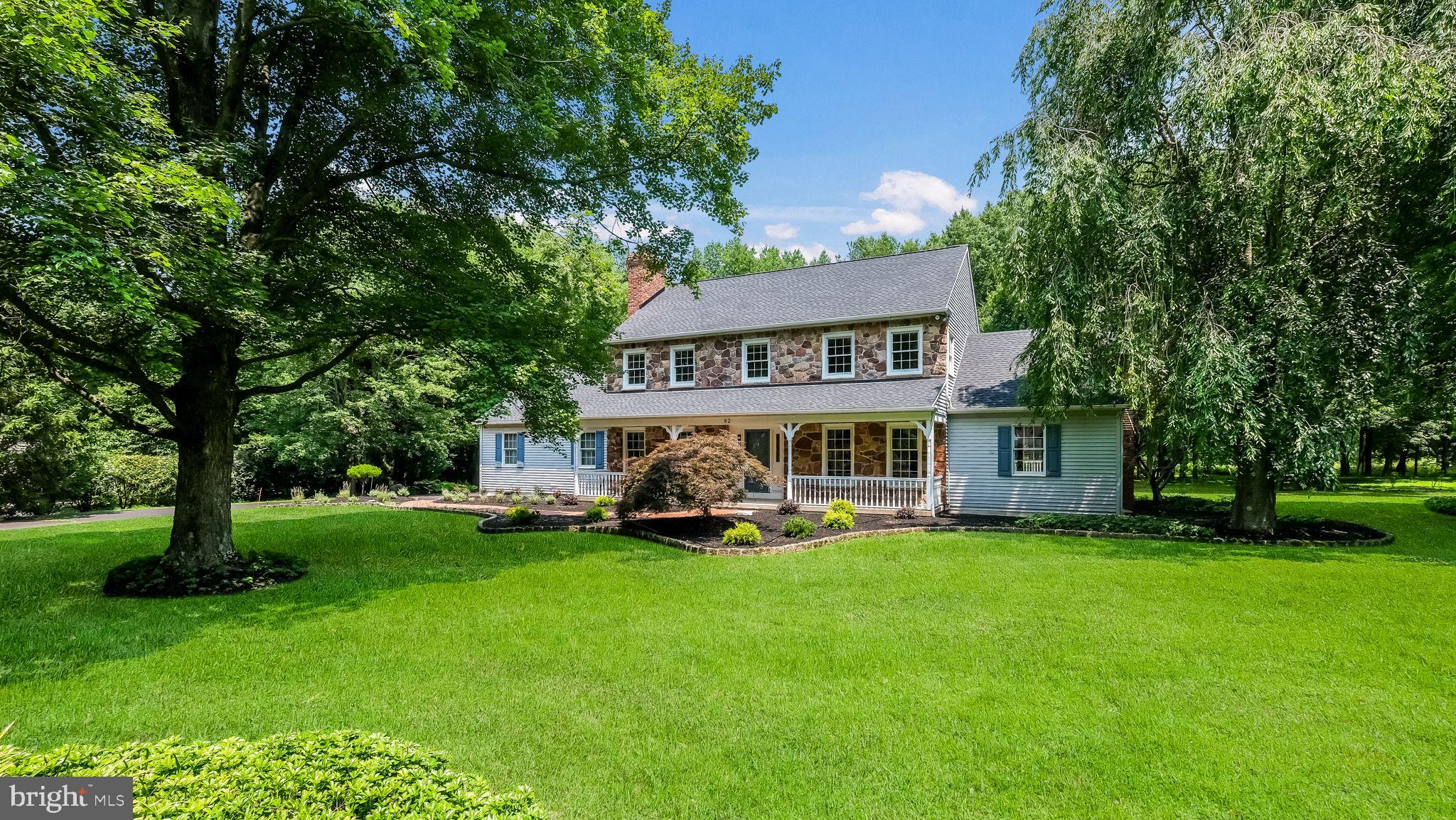Discover a hidden gem tucked away in a serene and picturesque location in Doylestown Township. Welcome to this charming Zavetta built center hall colonial, nestled on a generous 1.52 acre lot on a beautiful horseshoe shaped lane, just awaiting your personal touches. As you approach the property, you’ll appreciate the subtleness of the long driveway leading to the home, providing a sense of privacy and tranquility, as the home sits back off the road. Recent exterior updates include new landscaping and a new roof, to complement the property’s curb appeal. 
The brick walkway leads you onto the inviting covered front porch, adorned with real stone and stone window ledges, setting the tone for the quality within. Once inside, you’ll be greeted by spacious rooms boasting on-site finished hardwood flooring, enhancing the classic and warm ambiance of the home. Solid wood doors throughout add a touch of sophistication, while the abundance of closet space caters to your storage needs. The foyer leads to the formal living room and dining room, perfect for hosting gatherings and entertaining guests. Continue into the kitchen, complete with an inviting morning room that offers a delightful view of the expansive backyard adorned with mature landscaping, ensuring a sense of seclusion and peace. The spacious family room becomes the heart of the home, featuring a brick surround, woodburning fireplace, ideal for cozy evenings. Three sliding doors open up to an expansive composite deck, extending the living space and providing an opportunity for seamless indoor-outdoor living. The first floor also boasts a convenient powder room and a laundry room with a large pantry, adding to the practicality of the home. 
Ascend the turned staircase to the second level, where a grand primary suite awaits. This retreat features hardwood flooring, a marble surround woodburning fireplace, and an oversized walk-in closet with additional storage space beyond. The primary bathroom exudes relaxation with a soaking tub equipped with jets, a separate shower stall and a new vanity. Continuing on the second level, a bonus sitting room awaits, providing a versatile space for relaxation or hobbies. Two nicely sized bedrooms, along with a fourth bedroom, share a hallway bathroom. 
But there is more! The lower level has been recently finished and includes a full bathroom, offering a multitude of possibilities for this additional space. Enclosed by French doors, there’s an added room that further expands the potential of the lower level. In the unfinished section, Bilko doors provide convenient access to this level. You’ll also appreciate a new water softener and a brand-new HVAC/heat pump system for peace of mind. 
This special home offers timeless charm and is ready for its next owner to bring it up to date and enjoy for many years to come.