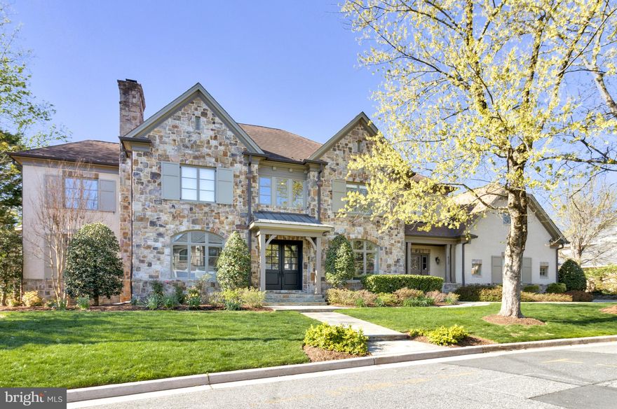 This spectacular home is located on a premium lot in sought-after Country Club Hills. A slate walkway leads to a grand double door entrance, framed by elegant stone and brickwork, with professional landscaping, including mature shade trees and thoughtfully designed privacy plantings.

With 5 bedrooms, 5 full and 2 half baths, and 8,200 sq ft of living space on three levels, the space has been transformed with nearly $600k in updates, inspired by Jodi Macklin Interior Design. The main level features 10’ ceilings, espresso-stained hardwood floors, high baseboards and crown molding. The wide central hall welcomes you to a formal living room with a cozy wood-burning fireplace and a separate dining room with wainscoting detail - both bathed in natural light from oversized windows. There is a gorgeous main level office with custom built-ins and expansive windows on three sides. A sleek wet bar, with painted black cabinets, under counter lighting and wine refrigerator, leads to the welcoming family room with a gas fireplace, coffered ceilings, and direct access to the large deck where you can enjoy seasonal views of the Washington Golf course and leafy privacy in warmer months. The impressive gourmet kitchen, with table space for informal meals with friends and family and a butlers pantry, showcases an oversized island with seating for 4, tons of cabinet storage, dramatic light fixtures and high-end appliances, including a six-burner cooktop, warming drawer, double wall ovens and two dishwashers. A family entrance with mudroom area, provides access from the three-car garage, and is conveniently located near a second main level powder room, coat closets and laundry room. Just off the kitchen, a back staircase leads to a private apartment with a full bath and large closet, perfect for accommodating in-laws, a nanny, or guests.

The upper level features the spacious primary bedroom suite, with a gas fireplace, oversized windows, two walk-in closets and a separate sitting room that could double as an additional home office. The primary bath has two separate vanities, a soaking tub and separate walk-in shower and separate water closets. Two well-proportioned ensuite bedrooms, a laundry room and a sun-soaked sitting area with custom built-ins and views of Bethesda and Chevy Chase complete this level. 

The fully finished walk-out lower level, accessed by front and rear staircases, features a bedroom, a full bath, family room with a gas fireplace, media room, exercise room, a bar, and even more flex space, with direct access to a covered stone patio. 

This meticulously maintained and beautifully designed home offers a luxurious and comfortable lifestyle in a highly desirable location. With its spacious layout, high-end finishes, and thoughtful amenities, this property is truly exceptional.