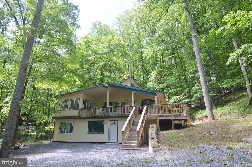 Plenty of space in this fabulous 4 bedroom, 3 full bath home at Coolfont Mountainside.  Plenty of extra sleeping areas for groups. Home has been in current owner's family for generations. Sitting right in the middle of Berkeley Springs and Cacapon State Park, this home has a lot to offer. The community has a swimming pool, hot tub, hiking trails, tennis courts, a playground, and much more.  Inside features hardwood floors, pine tongue and groove ceilings in the living room, and a fireplace.  Furnishings can convey as well, making this a turn key home to start relaxing in.  Home is a successful vacation rental as well if you would like to go that route. Recent remodel with very nice features.  Lots of natural light and the home sits in a nice wooded setting.  A must see!