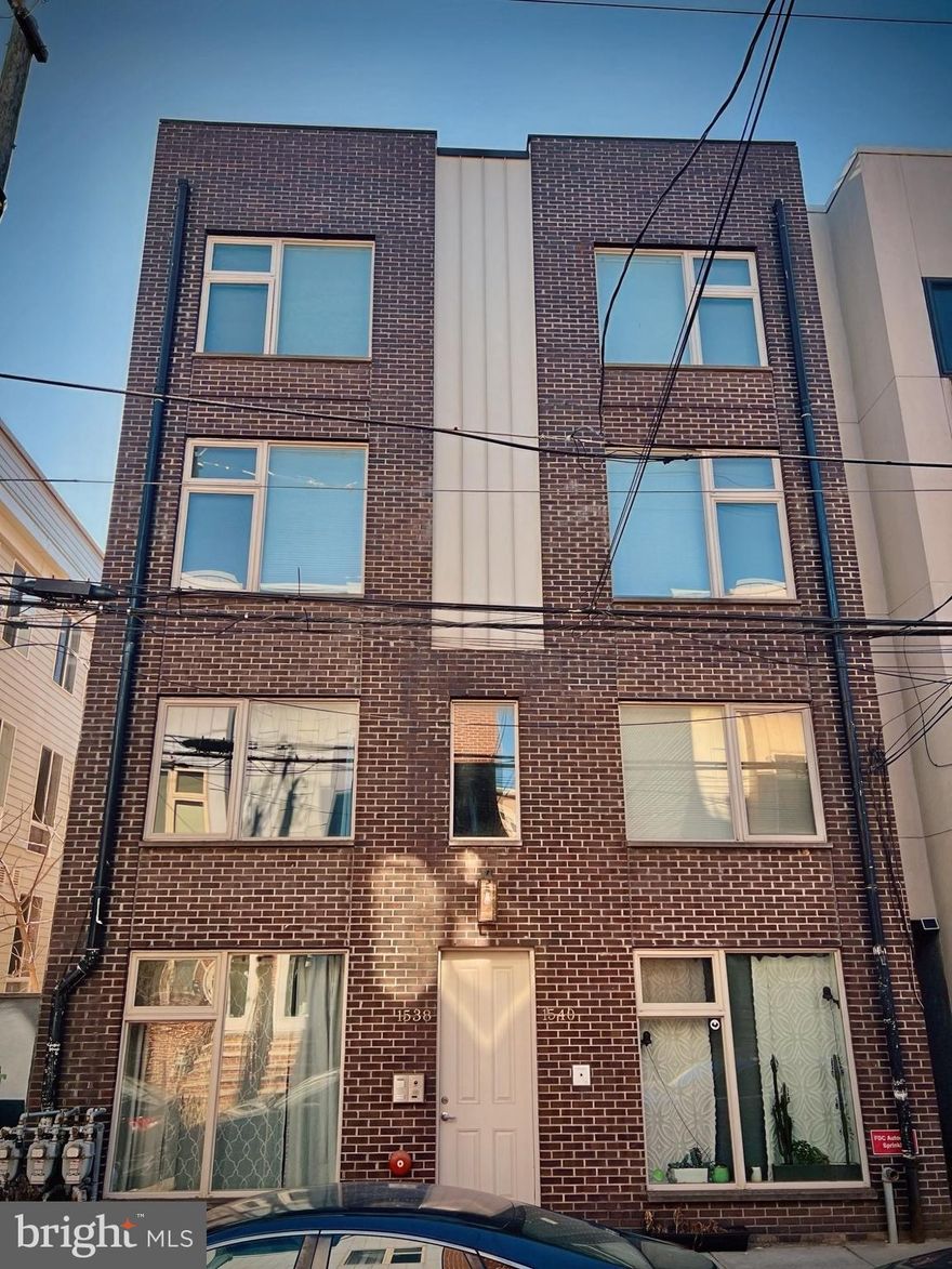 Discover modern city living at 1538-40 Ogden Street #1A, an expansive first-level condo perfectly situated just outside Center City Philadelphia. Located one block from Broad Street, this home offers unparalleled convenience with premier dining, bars, and entertainment venues like the MET, Kelly Drive, and the Art Museum all within walking distance. Commuting is effortless with the Broad Street Line and bus routes just a 3-minute walk away, and major highways are easily accessible.

This condo feels like new construction, boasting 12-foot ceilings, sleek hardwood floors, and recessed lighting throughout. The wide living area is complemented by large windows at the front and back, allowing natural light to flood the space. The spacious kitchen is equipped with stainless steel appliances and plenty of storage, making it ideal for cooking and entertaining. A private patio offers a serene outdoor retreat, while personal storage within the apartment and a Nest thermostat enhance functionality and comfort.

Additional highlights include a full bathroom with tiled floors and upgraded fixtures, a brand-new hot water heater, and built-in security and intercom systems for added peace of mind. This pet-friendly home (on a case-by-case basis) is available for rent furnished or unfurnished at no extra cost. Plus, the responsive landlord, who also serves as the property manager, ensures a seamless and hassle-free living experience.

With its prime location, modern amenities, and thoughtful design, this condo offers easy city living at an unbeatable price. Schedule your tour today and make this vibrant space your new home!