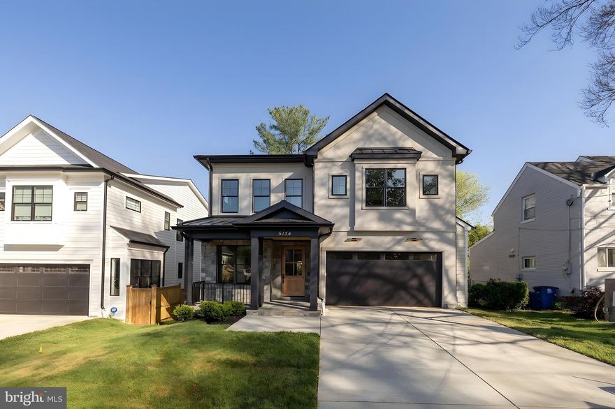 Welcome to 5134 Newport Avenue, a beautifully crafted new construction home offering a thoughtfully designed floor plan and seamless indoor-outdoor living, set on a quiet, tree-lined street in close-in Bethesda.

A welcoming front porch leads into light-filled interiors featuring wide-plank hardwood floors, tall ceilings, and oversized windows throughout. The formal dining room is detailed with chair-rail wainscoting, a tray ceiling, and designer lighting, creating an elegant setting for entertaining. The expansive living and family room is anchored by a fireplace with custom millwork and opens directly to the rear deck through a wall of glass, blending indoor and outdoor living with ease.

The gourmet kitchen is designed for both function and style, complete with an oversized island, double-stacked cabinetry, stainless steel chef-grade appliances including a gas range and double wall ovens, and custom pendant lighting. The adjacent deck offers a gas line for grilling or a fire feature and overlooks the landscaped backyard.

The main level is completed by a walk-in pantry, mudroom, powder room, and direct access to the two-car garage.

Upstairs, four bedrooms include two en-suite layouts and a well-appointed buddy bath, all with generous closet space and hardwood flooring. The primary suite serves as a private retreat, featuring dual walk-in closets with custom organizers and a spa-inspired bath with an oversized glass-enclosed shower, dual vanities, a soaking tub, and refined finishes throughout. A spacious laundry room with cabinetry and sink completes the upper level.

The walk-out lower level offers exceptional additional living space, including a large recreation room with direct access to the patio and yard, a wet bar area, a fifth bedroom with legal egress, a full bathroom, and a versatile bonus room ideal for a gym, media room, or office.

Ideally located just moments from everyday conveniences and destination shopping and dining, including Bethesda Row, Strathmore, and Whole Foods Market, with easy access to downtown DC, NIH, and Walter Reed.

A refined new construction offering combining design, scale, and location.