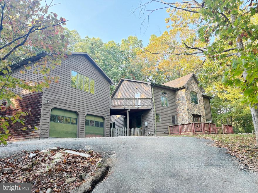 If you're looking for privacy in the woods, look no further! This contemporary-style home offers great potential and sits on 5 wooded acres just minutes from Rt 522/Rt 37. The great room offers a beautiful stone 2-sided fireplace, an open and spacious dining room area. There are lots of large windows for natural lighting throughout. The kitchen is just off the dining area. The main level bedroom and bath complete the first floor. The upper level is your spacious Primary Suite. Walk out onto the breezeway from the primary bedroom to the spacious bonus room above the 2-car garage! Perfect space for your game room, gym or office! Full unfinished basement to finish to your liking! This home will not qualify for government loans and is being sold in AS IS condition. Please see the documents and agent remarks for more information. Agents must accompany their buyers for all showings.