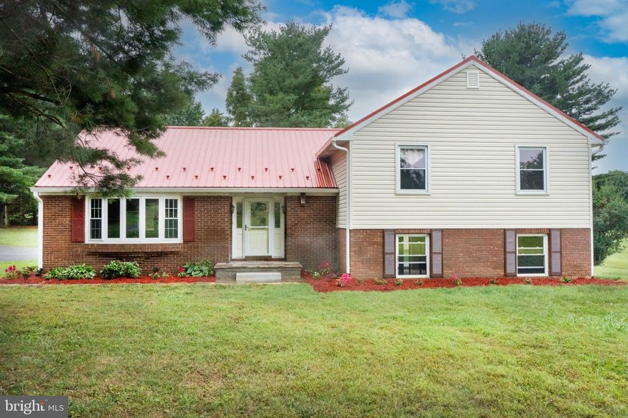 New Price! Fully renovated beautiful  home on 3.30 gentle rolling acres in a peaceful country location, yet close to all amenities. The home features four bedrooms, two full bathrooms, a 25X16 super spacious living room with bow window, separate formal dining room,  updated kitchen with new cabinets, new appliances, kitchen island , granite counters and a spacious pantry, as well as a new metal roof and new AC units. New carpet in all the bedrooms and luxury vinyl plank floors throughout the main floor. Lower level can be easily finished for additional living space and has a wood fireplace, plumbing for a full bathroom, utility sink and sliding glass door leading to a stone patio and beautiful backyard. units are also featured.