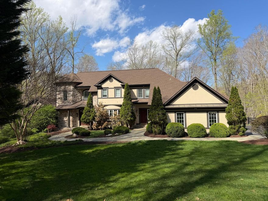 Tucked at the end of a private cul-de-sac on nearly 8 wooded acres, this extraordinary home
feels like a world apart, yet sits minutes from downtown Manassas, everyday conveniences, and
quick access to Routes 234, 66, 95, and 28. The mature tree canopy provides complete privacy
from the street and neighbors alike, and the resort-like setting announces itself before you ever
step through the door.

The connection to the outdoors here is exceptional. The property holds over 100 feet of
private frontage on the Occoquan River, with a dock perfect for launching kayaks, canoes,
and paddleboards into miles of open waterway. A private trail leads directly from the home
down to the water’s edge, and from there residents have access to a mile-long community
trail running right along the banks of the Occoquan. A serene, wooded path ideal for
morning walks, dog lovers, and families who want time along the river without ever getting in a
car. Two streams also border the property and feed into the river, adding to the sense of living
within nature rather than simply beside it.

Outside, the home lives like a private resort. A pool and spa anchor the backyard entertaining
space, with the walk-out basement connecting seamlessly to the pool deck. Tucked beneath the
deck is a covered outdoor area with its own gas fireplace, a perfect perch for cool evenings by
the pool or watching football on a crisp fall afternoon. The three-car garage handles vehicles
and gear with ease, and a large, nearly new shed offers additional space for watercraft, garden
tools, or workshop use. The wooded acreage surrounds it all, providing shade, privacy, and the
sounds of the natural world at every turn.

Inside, the home is appointed with five gas fireplaces in total, lending warmth and ambiance
to the living spaces throughout every season. The primary suite sits on the main living
level, a thoughtful layout that offers both convenience and seclusion, complete with two
generous walk-in closets and views into the trees. A light-filled flex room off the kitchen
works beautifully as a home office, breakfast room, or reading space. Three large bedrooms
occupy the upper level, and the walk-out basement adds a fourth bedroom with a full bath
opening directly onto the pool deck. All this alongside a remarkable 1,000 square foot
climate-controlled storage area. Combined with oversized closets throughout the home,
the three-car garage, and the outbuilding shed, storage here is genuinely without equal.

This is not simply a large home — it is a lifestyle. Mornings here begin with birdsong, the
rustling of leaves, and the deep green stillness of the woods — a natural soundtrack that
sets the tone for the day. It is a place where adults rediscover tranquility and children
thrive outdoors, where the pace slows and the noise of the world fades. And yet, everything
you need is close at hand — major commuter routes, shops, and amenities all within easy
reach. Peaceful and private, yet effortlessly connected. Properties that offer this rare
balance are extraordinarily hard to find. This is one of them.