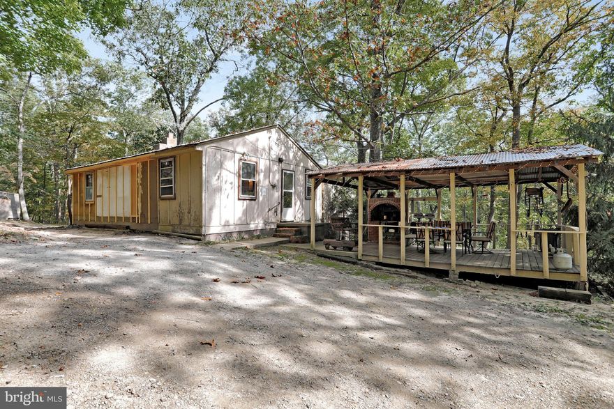 2 bedroom, 1 bath home with two wood stoves with brick hearths. The oversized Living Room has vaulted ceilings with exposed beams and built-in brick bar.  Some recent updates include a new water heater, pressure tank, well pump and updated electric, as well as, new wood ceilings.  This property will make you feel like you have your own private retreat with 3.08 acres.  Only minutes from Warden Lake and all the amenities Wardensville has to offer. This property would make a perfect permanent residence or weekend getaway with Interstates 81 and 66 so close.  Call to today to schedule an appointment!