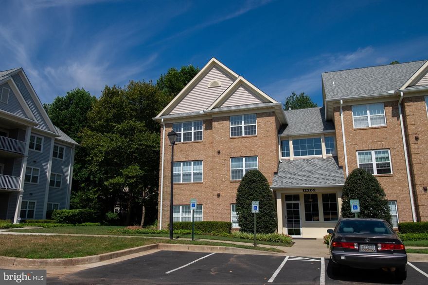 Sparkling 2 BR, 2 BA corner unit, ideally on top level affording vaulted ceilings and wonderful privacy, with spacious covered balcony overlooking a serene treed vista. Lovely hardwood floors in hallways and kitchen, with neutral carpeting thru-out living and bedroom areas. Features newer stainless appliances, new HVAC system, new Water Heater, new Dryer  and separate laundry room w/ full size washer & dryer. Freshly painted throughout with a Vintage Linen palette. Perfectly located within quiet court, backing to walking trail. Walk to pool & shopping. Missing blind in Primary Bedroom will be replaced. Move-in ready!