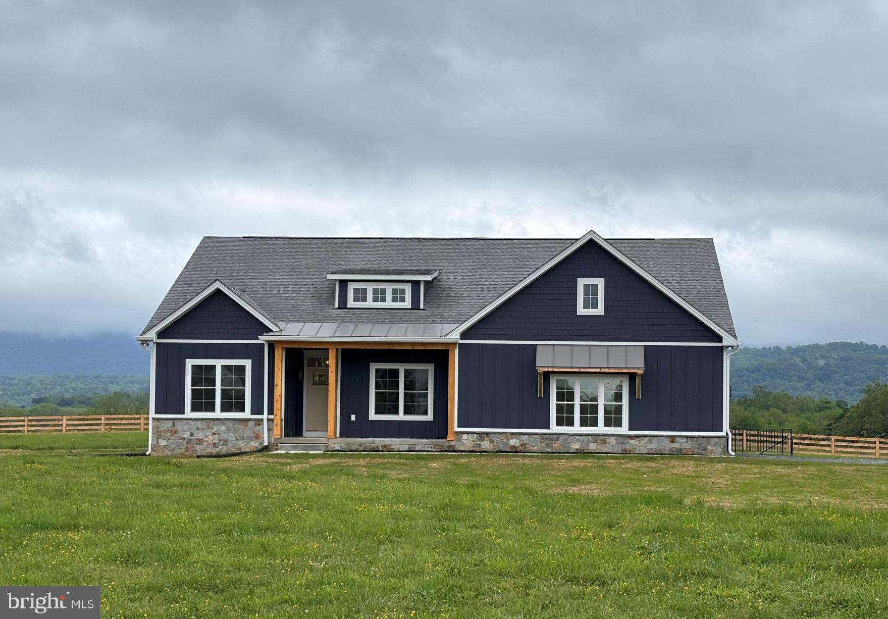 Exceptional custom Cape Cod home is to be built on a scenic, level lot just outside Shepherdstown. It is filled with the kind of quality details that will elevate your living experience. Enter from the covered porch and find a secondary bedroom, bathroom, and a study with double glass doors to your left. The great room ahead features a fireplace and soaring cathedral ceilings, creating a warm and inviting space. To your left, the chef-inspired kitchen boasts a 4x8’ island, and beyond that, a spacious sunroom overlooks the backyard. Double doors lead to a covered and screened porch, perfect for enjoying the views and wildlife. To the right, you’ll find the stairs and the primary ground-level suite, which includes a walk-in closet, dual sinks, and a spacious shower. Upstairs, a large bedroom with its own bath and a cozy sitting area offers an ideal private retreat, perfect for relaxation or quiet time. A broad range of customization options for flooring and finishes, allow you to personalize your home in a peaceful rural setting just minutes from historic Shepherdstown.