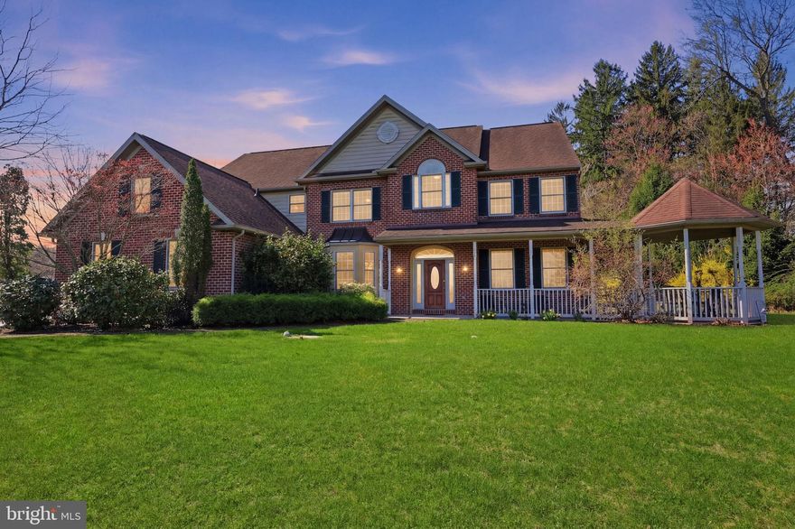 Welcome to this beautifully updated, sun-filled home where every window showcases beautiful, long-distance scenic views. From the moment you arrive, a paver walkway leads to the covered front porch, complete with a gazebo and recessed lighting—an inviting space to relax and unwind.  
Step inside to a bright and open foyer. To the right, a versatile bonus room features recessed lighting and custom built-in cabinetry—perfect for a home office, library, or flex space. To the left, the elegant dining room is designed to impress with a tray ceiling, crown molding, and chair rail—ideal for hosting gatherings.
The heart of the home is the fully updated kitchen, thoughtfully designed with stainless steel appliances, quartzite countertops, and a custom backsplash featuring concave tiles that beautifully reflect the natural light. The kitchen is loaded with high-end details, including illuminated glacier glass cabinetry, a spice mill cabinet, smart kitchen faucet, walk-in pantry, pull-out drawers for pots and pans, Lazy Susans in upper and lower cabinets, under-cabinet lighting, and recessed lighting throughout. The spacious island is a standout feature, offering pendant lighting, additional storage, and convenient electric outlets—perfect for both everyday use and entertaining. The bright eat-in area is highlighted by a beautiful custom blown glass chandelier, creating the perfect setting for everyday dining.  
Just off the kitchen, the inviting family room features a dramatic stacked stone wood-burning fireplace and recessed lighting, offering both warmth and style. A sunroom filled with natural light—complete with two skylights—provides access to the backyard, where you’ll find a beautifully lit paver patio, a deck perfect for outdoor dining and relaxation, and an oversized storage shed offering exceptional space—making outdoor entertaining effortless.
The first floor also includes a powder room and a well-appointed laundry room with ceramic tile flooring, utility sink, built-in cabinetry, and direct access to the backyard. A private home office, with an exterior side door from the driveway, adds convenience along with access to the spacious 3-car garage.
Two staircases lead to the second level—one from the foyer and another from the kitchen—adding both function and flow. The main staircase opens to a loft area featuring built-in cabinetry and a window seat, perfect for enjoying the picturesque views.
The primary suite is a true retreat, offering a sitting area, a large walk-in closet with access to additional storage space inside the closet, and a en-suite bathroom with ceramic tile flooring, a soaking jetted tub, stall shower, skylight, and a double sink vanity.  All bedrooms are equipped with ceiling fans for added comfort. Three additional bedrooms and 2 full bathrooms one being a jack and jill bathroom with ceramic tile, granite vanity and stall shower, as well as a beautifully updated hall bath finishes off the second level.  The finished basement expands your living space with recessed lighting, rough-in plumbing for a future bathroom, and two large storage areas—both equipped with storage shelving and one has a workbench.  Throughout the home, you’ll find beautiful woodwork including crown molding and chair rail, adding timeless sophistication. Other notable features include smart lighting, central vacuum system and alarm system. With its exceptional updates, thoughtful design, abundant natural light, and stunning views, this home perfectly blends luxury, comfort, and everyday functionality.