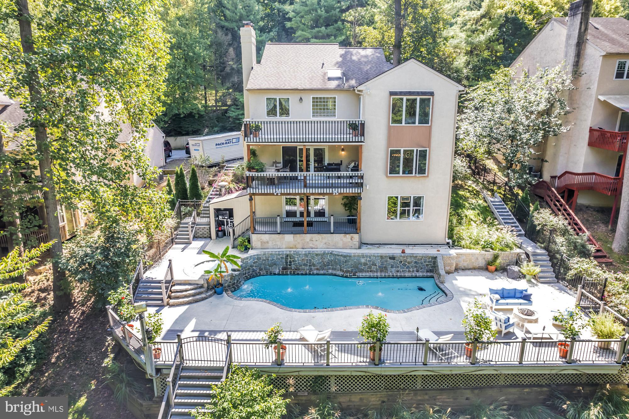 UNIQUE RESORT STYLE LIVING! The highlight of this three-story home is the Vail, Colorado-like setting, relaxing on a multi-level deck overlooking a salt-water pool, hot tub and tranquil grounds that include lush landscaping and stream. Upon entering this completely modernized home is the foyer with beautiful ¾” Lyptus hardwood floors that lead into its' open main living space. A stone gas fireplace is an invitation to unwind after a stressful day. Oversized glass patio doors lead to a cover deck perched high above your private Oasis. The Sun-drenched kitchen offers oversized windows, with new maple cabinets, soapstone countertops, stainless dual sinks, custom tiered breakfast bar, stainless appliances and a five-burner chef’s stove. Traveling up the impressive staircase to the owner’s suite…another breathtaking space that will make every night feel like you are on vacation features a dramatic cathedral ceiling with a wood beam, hickory hardwoods, and its' own private deck overlooking the pool, yard and creek as well a NEW luxurious full bath, oversized shower with frameless glass door, custom vanity also with a vaulted ceiling a. Three bedrooms, ample closets, New laundry area and remodeled full bath complete the upper level. The lower level is above grade with an abundance of light coming from the large patio doors and windows, making this space great for casual gathering around the stone fireplace, extensive wainscoting and full bath. This additional square footage is ideal for an in-law or au pair suite, or at-home office. Exiting from the ground level is the third deck and access to heated pool and hot tub accented by gorgeous field stone, waterfalls, fountains and gas fire pit. Just imagine the incredible pool parties! All this privacy, yet you are so close to major routes like Turnpike, 276, 476, 76, 422, 202, 30, 320 and multiple train stations. Only minutes to Center City Philadelphia, Wayne, Villanova, King of Prussia and Conshohocken. Convenient two car attached garage and driveway parking. Easy to Show
