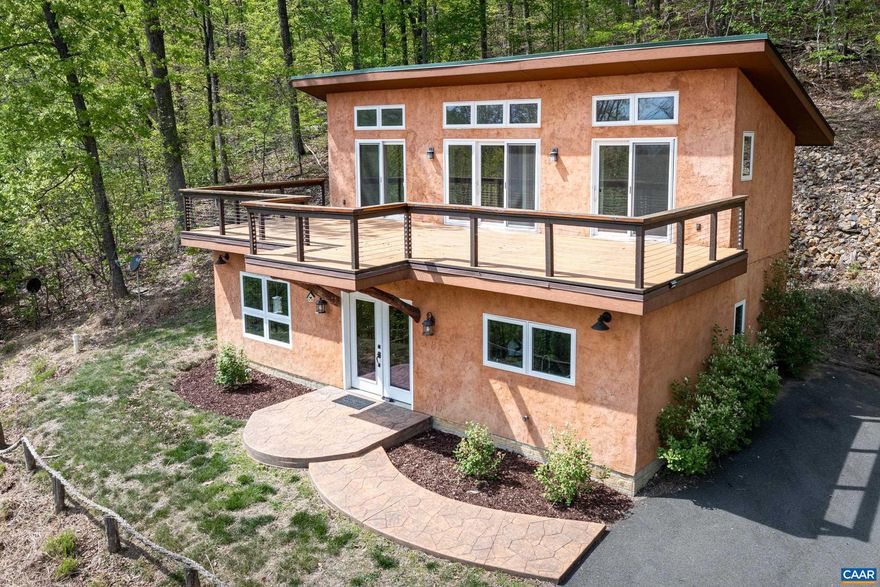 If you are looking for a quality built, energy efficient home that offers peace, quiet, privacy and amazing mountain views, then you need to visit the Limehaus, named for the natural hydraulic lime used on the exterior of the home.  The 1st floor of  Limehaus has a primary bedroom & bath, kitchen, living room, dining area, 1/2 bath and laundry.  Upstairs you'll find a full bath and 2 more bedrooms that walk out to a spectacular deck where you can enjoy the spectacular views.  Limehaus was designed for energy efficiency and a healthy indoor environment.  It uses a passive solar design to keep utility bills low and enjoys radiant floors on the main floor for comfortable heat in the winter.  Tankless hot water heater and a gas range are also a plus.  The yard is low maintenance, planted with native grasses, wildflowers and wetland perennials.  The Property consists of two lots, the house is on 1.94 acres and the adjoining lot is 3.4 acres.  The neighborhood, Farm Colony, is a working Farm and the residents of the neighborhood can fully enjoy Farm life without having to own and maintain an entire farm.   This is a Greene County MUST SEE!,Granite Counter,Wood Cabinets