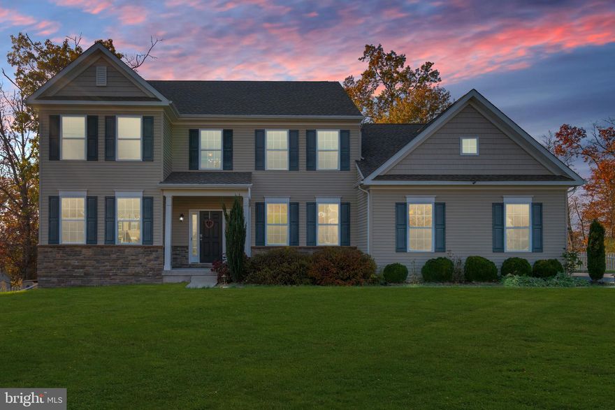 Welcome to this stunning 2014-built Colonial in one of Green Lane’s most coveted 36-home enclaves, where half-acre+ lots ensure privacy and elbow room. Set on a manicured 0.58-acre lot with a white picket-fenced backyard, this home delivers curb appeal and a serene, wooded backdrop you’ll never tire of.

Step inside the soaring two-story foyer and feel the space unfold. To your left: a versatile home office (or formal living room). To your right: an elegant dining room with gleaming hardwood floors that flow seamlessly into the heart of the home—an open-concept kitchen, breakfast nook, and family room drenched in natural light. The chef’s kitchen boasts two-tone cabinetry (rich wood island + creamy perimeter), granite counters, and a propane range. A slider off the breakfast area opens to the expansive elevated Trex deck—perfect for morning coffee or sunset dinners—overlooking the peaceful, tree-lined yard.

Rare main-floor bedroom + full bath creates instant in-law or guest suite potential (or ideal for anyone prioritizing single-level living). A convenient laundry room and direct two-car garage access complete the first level. 

Upstairs, retreat to the spacious primary suite with its oversized walk-in closet and private en-suite featuring a stand-up shower. Three additional well-proportioned bedrooms and a second full bath ensure room for everyone. 

The 2020-finished walk-out basement is an entertainer’s dream: high-end finishes, wet bar, luxurious full bath with soaking tub + tiled shower, massive TV/rec area, and flexible bonus space (currently a gym—imagine a pool table, playroom, or home theater). A non-egress flex room offers overflow sleeping, office, or hobby space, plus ample storage behind. 

Outside, the deck spills into a flat, usable yard framed by mature trees—ideal for play, gardening, or simply unwinding in nature. Just minutes from Green Lane Park (hiking, fishing, kayaking) and served by the acclaimed Upper Perkiomen School District.

This is move-in-ready colonial living with flexibility for multi-generational families, remote workers, or anyone craving space without sacrificing style. Schedule your private tour today—homes like this don’t last.