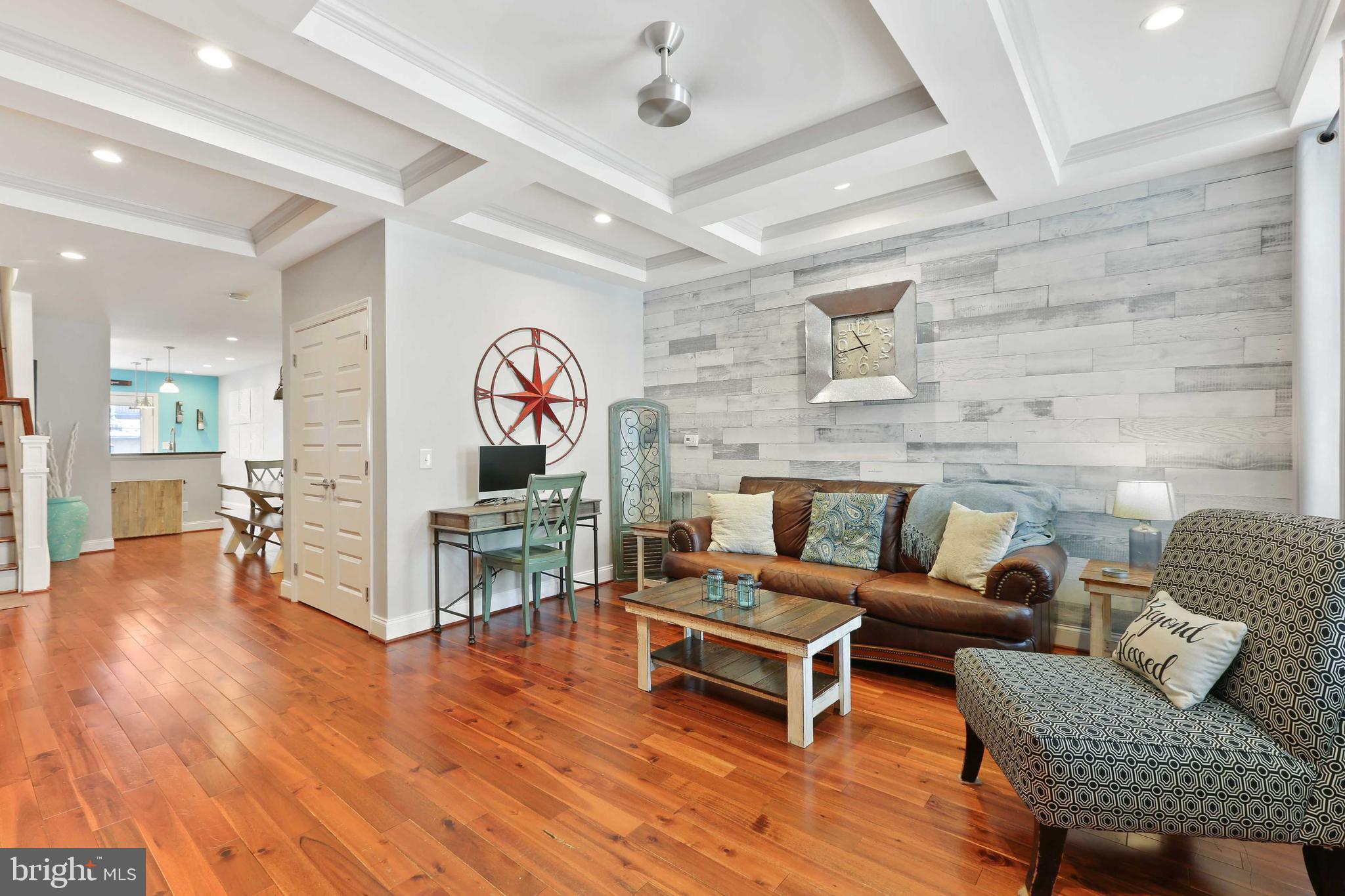 Stunning recently renovated home with 5 years left on CHAP! This wide home has hardwood floors throughout. Living room with coffered ceiling, exposed brick and recessed lighting. Dining area with built-in wet bar. Kitchen has white shaker cabinets, subway tile back splash, island, stainless steel appliances and exhaust hood. Back deck off kitchen. Primary bedroom with en suite bath with stand up shower and huge walk-in closet with custom closet organizer. Second bedroom and full bath on upper level. Custom built-in closets throughout upper level. Fabulous roof top deck! Full finished WALK OUT basement with full size windows, third bedroom, full bath and rec room...unbelievable space! Rare Sub Basement for additional storage. Exit the lower level to another outdoor space...this one is a fully stoned patio...perfect for entertaining. This home is must see!
