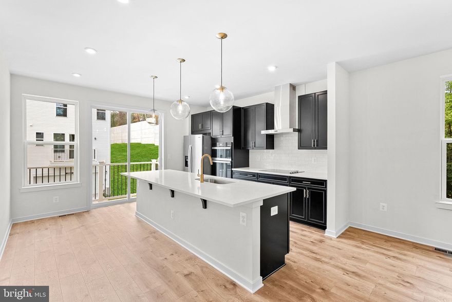 *NEW CONSTRUCTION* Special All-In Price, Immediate Move-In! Discover the Belle, a stunning 3-level end-unit townhome with a 2-car garage in the highly desirable Cascade Landing community in Dumfries, VA. This spacious home offers 3 bedrooms, 3.5 baths, and a finished recreation room, all with 9 ft. ceilings for an open, airy feel. The gourmet kitchen is a showstopper, featuring upgraded black shaker cabinets with gold hardware, pendant lighting, quartz countertops, tile backsplash, a large pantry, range hood, microwave/wall oven, and stainless-steel Whirlpool appliances. Designer laminate flooring flows throughout the main level, including the kitchen, great room, and foyer, creating a sleek, modern look. The luxurious primary suite includes a generous walk-in closet and a spa-inspired bathroom with raised double vanities, quartz countertops, and a ceramic tile shower with seat. Plus, the garage includes an EV charger-compatible outlet, making this home future-ready. Limited-Time Incentives: Get $20K in Closing Costs until 1/31. Hometown heroes get $2,500. See New Home Counselor for details. Enjoy low-maintenance living with affordable HOA dues (no hidden developer fees) so you can put your savings toward what matters most. Cascade Landing offers a welcoming neighborhood with a playground, easy walkability, and quick access to premier parks and trails. These advanced performance homes save you money on utilities while reducing your carbon footprint. Located just 2 minutes from Marine Corps Base Quantico (North Gate) and with direct access to I-95, commuting is effortless. Plus, you’re close to Fortuna Center Plaza, Locust Shade Park, and dining favorites and entertainment. Model Home Hours: Mon–Sun, 11 AM–6 PM. Use 17910 Alicia Avenue, Dumfries, VA 22026 for GPS directions.