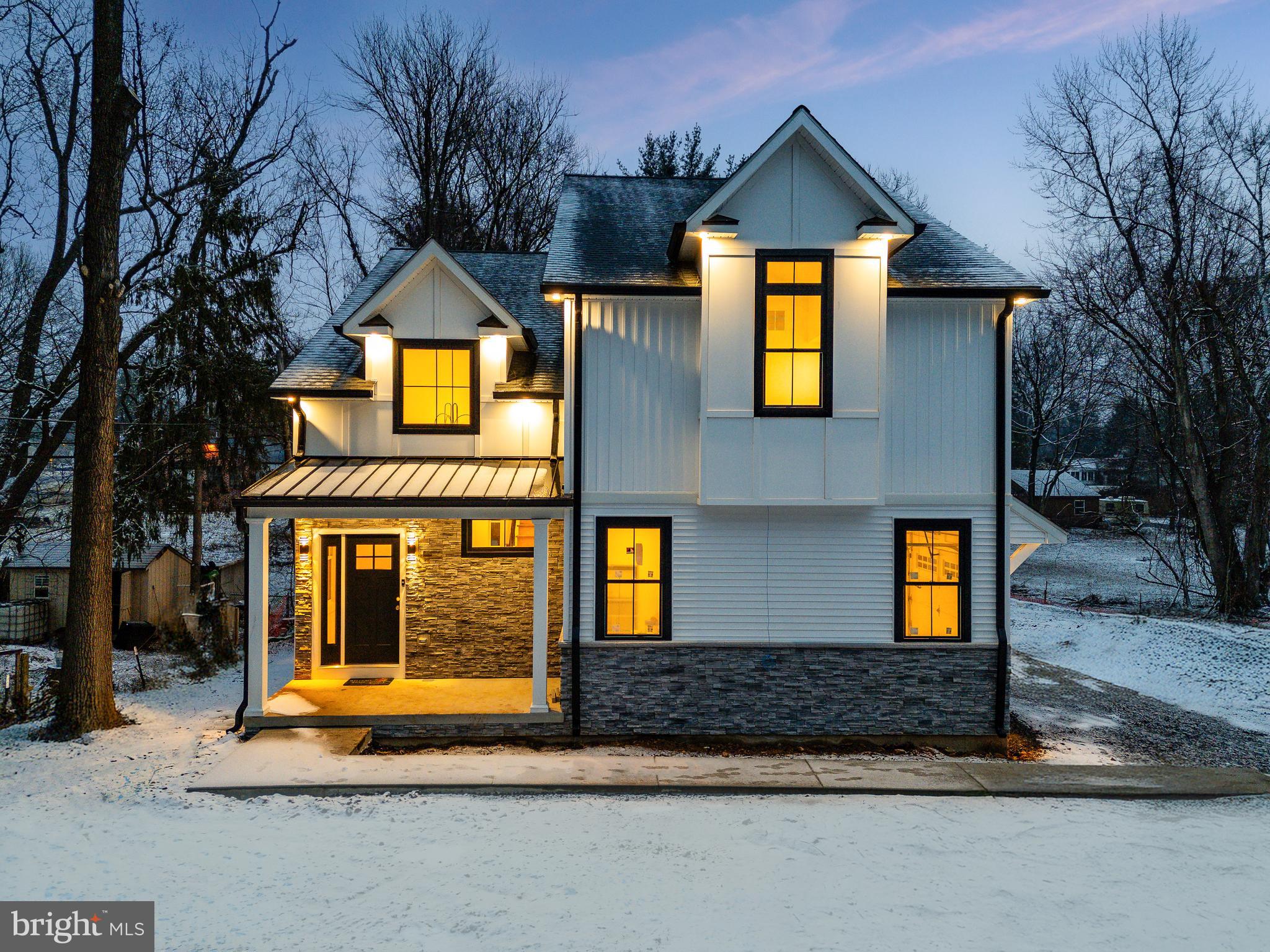 Introducing 18 Churchville Ln, the first of three exclusive custom farmhouse style homes in the highly anticipated Churchville Pointe enclave. This stunning 4-bedroom, 3.5-bathroom farmhouse-style home blends timeless charm with modern luxury, offering an expansive open floor plan and impeccable craftsmanship throughout. Step inside the soaring two-story foyer, where wide-plank white oak flooring flows seamlessly throughout the home. The spacious living room, centered around a gas-burning fireplace, provides the perfect setting for both relaxation and entertaining. A dining area, conveniently situated between the living room and kitchen, features a wet bar with a wine refrigerator, adding a touch of elegance to your gatherings. The heart of the home is the gourmet kitchen, a true showstopper with custom two-tone thin shaker cabinetry, gorgeous quartz countertops, an oversized island, and high-end Café stainless steel appliances. Adjacent to the kitchen, a custom-built mudroom ensures stylish and functional organization. Through the mudroom, you'll find access to both the spacious two-car garage and a massive walk-in pantry. A striking custom iron railing with oak box handrails leads to the second floor, where each generously sized bedroom is designed to accommodate a king-size furniture set. The primary suite serves as a luxurious retreat, complemented by a spa-like en-suite bath featuring stunning wall-to-wall large-format porcelain tile, a free-standing soaking tub, a double vanity, a private water closet, and an oversized glass shower stall. The convenience of an upstairs laundry room adds to the home’s thoughtful design. Enjoy seamless indoor-outdoor living with a large, elevated Trex deck, perfect for entertaining or quiet moments overlooking the serene surroundings. The daylight walk-up lower level is an entertainer’s dream, complete with an additional full bathroom—ideal for a guest suite, home gym, or media room. Additional highlights include Andersen windows, a high-efficiency HVAC system, and a spacious two-car garage. Nestled in a coveted location, 18 Churchville Ln offers a rare opportunity to own a one-of-a-kind custom home in a picturesque setting, conveniently close to major transportation routes and the charming hamlets of Richboro, Newtown, and New Hope. Experience the pinnacle of modern farmhouse living at Churchville Pointe—schedule your private tour today!