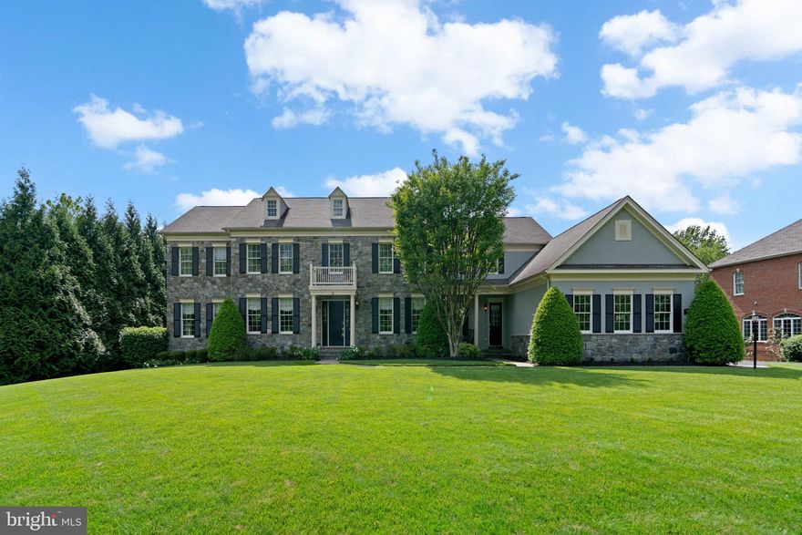 Tucked away on a private, tree-lined acre backing and fronting to conservation land, this exquisite estate in the prestigious Patuxent Chase community, lovingly maintained by the original owners, offers an exceptional blend of timeless elegance and resort-style living. A striking stone and stucco exterior and beautifully manicured landscaping create picture-perfect curb appeal. Step inside to discover a home crafted for luxury and leisure. The traditional yet open layout features rich hardwood flooring, custom window treatments, upgraded lighting, elegant trim, and fresh paint [2023] throughout the main level, setting a warm and sophisticated ambiance. 

Enter the grand foyer, flanked by a formal living room to the left and a formal dining room to the right, accented with wainscotting. Continue into the heart of the home: a stunning family room with a wood-burning fireplace adorned with floor-to-ceiling stone. The family room flows seamlessly into the fully remodeled gourmet eat-in kitchen, a showstopper completed in 2022 featuring custom solid walnut cabinetry by Plato Woodwork, a quartersawn walnut island, quartz countertops, marble backsplash, travertine flooring, a custom coffee bar, under-cabinet lighting, glass-front illuminated cabinetry, and a cozy breakfast nook with exterior access. Off the kitchen is a beautifully updated laundry room with a farmhouse sink, and the garage with a Tesla charger setup for dual charging. Also on the main level, a private study with bay windows and built-ins offers a perfect work-from-home setup. Just off the living room, a spacious in-law or au pair suite includes a sitting room, walk-in closet, and full bath—perfect for multigenerational living.

Upstairs, five generously sized bedrooms and five full bathrooms offer comfort and privacy for all. The luxurious primary suite impresses with a tray ceiling, large sitting room, electric fireplace, two walk-in closets, and a spa-like en suite bath with a jetted tub, separate shower, and dual vanities. The suite was recently updated with lighting, painted cabinetry, and mirrors in January 2025.  Four of the additional bedrooms feature attached bathrooms, and four include walk-in closets—one with two walk-in closets for added storage. Carpeting and fresh paint were completed upstairs in January 2025. All bathrooms feature granite countertops and porcelain tubs.

The fully finished lower level is an entertainer’s paradise, showcasing luxury vinyl plank flooring and fresh paint (2022) throughout a spacious recreation area with a surround system and walk-up access to the backyard. Highlights include a game zone, a wine cellar, a mini bar with refrigerator and ice maker, an infrared sauna, a gym, a gas fireplace, a half bath, and two large storage rooms. 

Outside, enjoy a private backyard retreat with a heated saltwater pool with waterfalls, a 12-person spa, and a fully equipped outdoor kitchen. A curved Trex® deck, stone patio, sound system, landscape lighting, irrigation, lush privacy plantings, and a fully fenced yard with a storage shed.