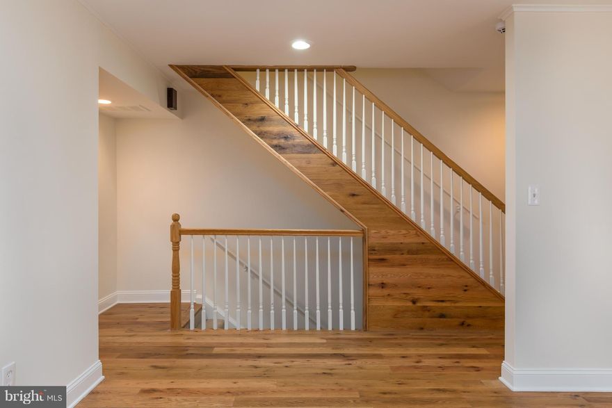 Your home is your castle, why not a castle by an enchanted forest? Relax on your deck (or shaded brick patio) and survey your domain amidst the rustling foliage. Or explore more than 20 miles of local trails. But don't forget all this is in Reston just minutes from Dulles and Leesburg Pike. Inside is no less enchanting with unique reclaimed wood floors, granite counters, and a flexible floorplan.