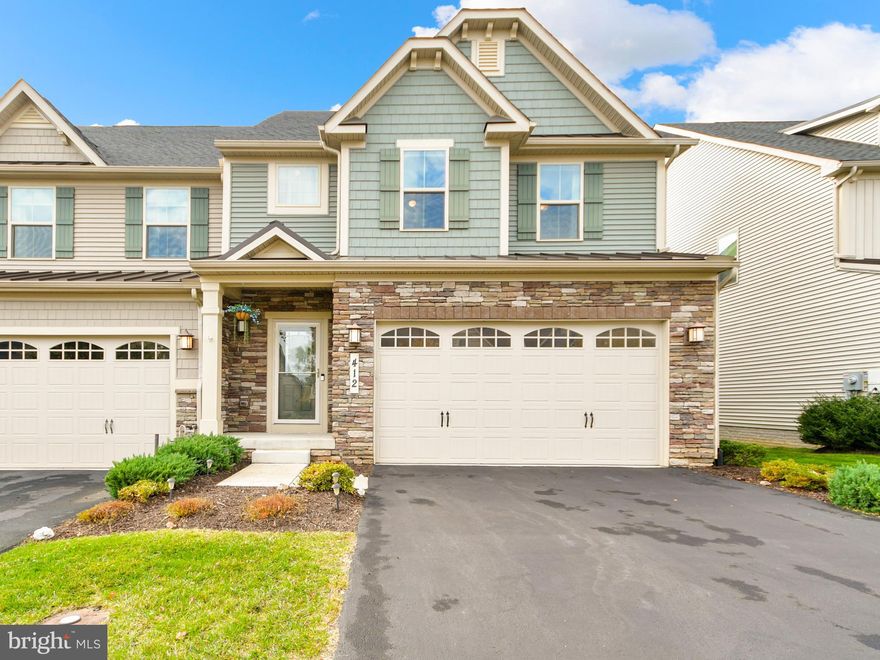 Enjoy ultimate convenience with the primary bedroom, living space, and kitchen seamlessly situated on the main level of this end unit villa. The kitchen is a culinary haven with a spacious island, ample cabinets, and generous counter space. Just off the kitchen, you'll find a convenient powder room, laundry room, and direct access to the garage. The kitchen seamlessly flows into the open floor plan, which encompasses the dining area and living room, creating a versatile space for both entertaining and relaxation. The living room is a cozy retreat with a gas stone fireplace, a vaulted ceiling, and easy access to the deck and backyard. Completing this level is the primary bedroom, featuring an en suite bathroom and a walk-in closet for your comfort and convenience. Moving to the upper level, you will discover three generously sized bedrooms, a full bathroom, and a bonus loft space that overlooks the living room. The loft space can serve as a home office or an additional living area. The fully finished lower level offers additional living space and includes a full bathroom with a luxurious soaking tub. It also features a workshop, ample storage, and a walk-up for easy access to the backyard. Outside, the property provides an inviting outdoor space with a trex deck, an oversized hardscape patio, and a fenced-in yard, creating an excellent area for relaxation and outdoor gatherings. The home is complete with a two-car garage and driveway space. The community offers a range of amenities, including a pool, clubhouse, walking trails, tot lots, and more. The HOA covers grass trimming and mulch, a bonus feature that simplifies your exterior maintenance. The Brunswick location provides proximity to the MARC train and commuter routes. For a full list of updates from the homeowners, please refer to the disclosures