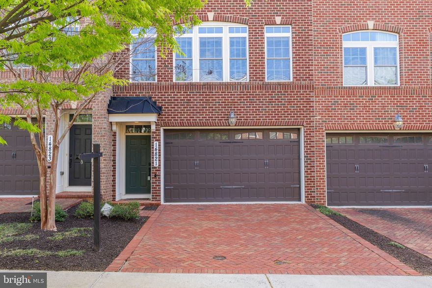 Welcome to 14821 Wootton Manor Ct – a beautifully brick-front townhome in the desirable Wootton Crossing community of Rockville.  This spacious home offers three finished levels of thoughtfully designed living space. Inside, you’ll find hardwood floors throughout the main living area and 9-foot ceilings on all three levels, creating a bright and open atmosphere. The gourmet Signature Kitchen is equipped with granite countertops, stainless steel appliances, maple cognac cabinetry, and refined finishes throughout. Upstairs, you’ll discover a light-filled and restful retreat with three generously sized bedrooms, each designed for comfort and privacy. The spacious owner’s suite features a tray ceiling and a spa-inspired bath that invites you to unwind. Thoughtful touches continue with elegant wheat granite countertops in all full bathrooms and the convenience of laundry on the bedroom level—making daily routines feel effortless. The lower-level recreation room is pre-wired for theater sound and includes in-ceiling speakers, making it ideal for movie nights or entertaining guests. Smart home features like a Nest thermostat, doorbell camera, and a central hub for phone, cable, and WiFi offer both convenience and connectivity. The garage has been upgraded with slatwall panels for efficient storage, and a tankless water heater enhances the home’s energy efficiency. Enjoy the convenience of a two-car attached garage, as well as access to the tot lot. Just minutes from the vibrant shops and dining of Rockville Town Center—and with easy access to I-270, Shady Grove Metro, and Rockville Metro—this location blends comfort, style, and accessibility. Don’t miss your chance to own this beautifully maintained, feature-rich home in one of Rockville’s most sought-after neighborhoods.