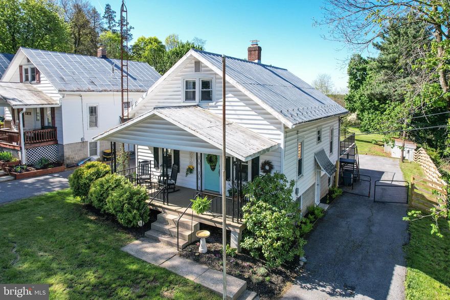 Tucked along picturesque Littlestown Pike in Westminster, MD this enchanting property captures the essence of a storybook cottage with a setting that feels both serene and inspiring. From the moment you arrive, you’re greeted by a sense of calm, where  the gentle rhythm of the countryside invites you to slow down and stay awhile.
A welcoming front porch sets the tone for the home, perfect for long, leisurely mornings with coffee or quiet evenings spent porch sitting as the sun dips below the horizon. It’s an inviting space that naturally becomes part of everyday living. Ideal for conversation, relaxation, and taking in the peaceful surroundings.
Inside, this charming two bedroom, one bath home is filled with warmth and character, where cozy spaces blend effortlessly with natural light. Every window offers a glimpse of the surrounding landscape, creating a seamless connection between indoors and out. It’s the kind of place where mornings begin with sunlight streaming in and evenings wind down with a soft, breezy tranquility.
Outside, the property truly shines with a large, open lawn that offers endless possibilities! From gardening and recreation to hosting gatherings on the large back porch. The two car garage along with a large outbuilding add both function and flexibility, perfect for storage, hobbies, or creative use. Expansive views and fresh air enhance the atmosphere. Ideal for quiet reflection, entertaining, or simply enjoying the beauty of nature on over a half of an acre!
Adding to its appeal, this home represents a rare opportunity as one of the least expensive detached properties in Carroll County, Maryland, offering exceptional value without sacrificing charm, space, or setting.