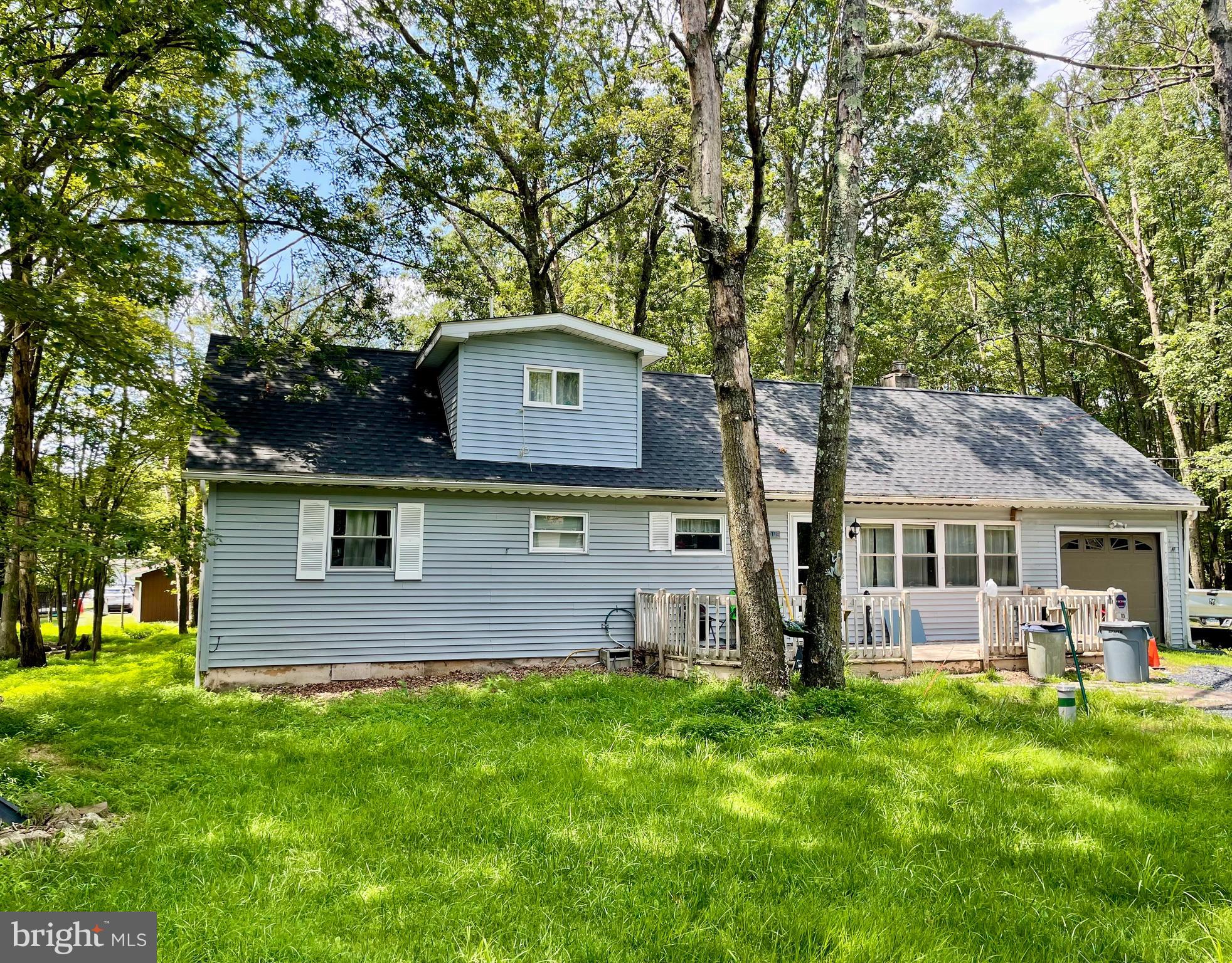 Welcome to Your Pocono Retreat! This charming 2-story home offers 1,690+ square feet of comfortable living space in an amenity-rich, short-term rental-friendly gated community—perfect for year-round living, a vacation getaway, or a smart investment opportunity. Step into a spacious living room featuring a cozy wood-burning stone fireplace, ideal for chilly evenings. Just one step up, you'll find a bright kitchen and dining area, complete with French doors that open to your private, fenced-in backyard—perfect for entertaining or relaxing in peace. The main floor includes a generously sized bedroom and full bath, while upstairs, an open loft area leads to two more bedrooms and a bonus den—great for a home office, playroom, or guest space. Situated on nearly half an acre (0.47 acres), the home is conveniently located near one of the two outdoor swimming pools, a snack bar, and the school bus stop. Explore the community by golf cart, with access to five scenic lakes, hiking trails, tennis courts, and a basketball court—there's something for everyone! Recent upgrades include: Brand new roof, New well pump, All-new baseboard heaters, Two new Mini-Splits for efficient heating and air conditioning. With low property taxes (under $2,500/year) and affordable dues ($1,260/year), this is your chance to enjoy the best of the Poconos without breaking the bank. Don't miss out—schedule your tour today and start living the lifestyle you've been dreaming of!