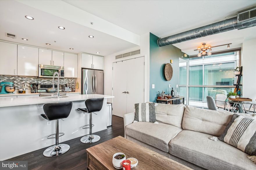 Welcome home to Virginia Square and the stunning ARC Building! This contemporary 1 bed, 1 bath unit is bathed in natural light, thanks to its floor-to-ceiling windows. The smart layout ensures maximum privacy and entertainment space, with the living and sleeping areas at opposite ends of the unit. In the open concept living area, you'll find a tastefully upgraded kitchen featuring white cabinetry, quartz countertops, and stainless steel appliances. Enjoy one of the two private balconies for al fresco dining or entertaining.The bedroom wing offers a serene retreat with a walk-in closet, direct access to the bathroom, and a second large balcony. This unit also includes the convenience of in-unit laundry and 1 reserved underground parking spot. Recent upgrades, such as a new HVAC system (2022) and water heater (2020), add further value, making this home absolutely move-in ready! The ARC boasts a range of amenities, including a concierge, fitness center, bike room, and a rooftop lounge with breathtaking views of Arlington. The building is pet-friendly. Living at The ARC places you within walking distance to the Virginia Square Metro station and a plethora of local shops and restaurants. Embrace the vibrant lifestyle this home and its location has to offer. Your new home awaits at The ARC!