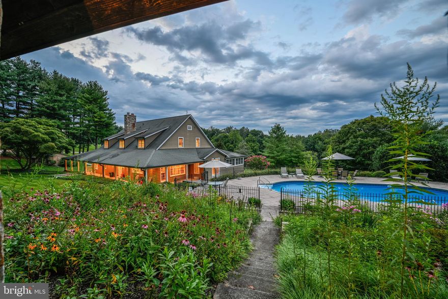 ACTIVE UNDER CONTRACT WITH KICKOUT. 

Live authentically. Take the road less traveled. Look forward to driving the country lane meandering through the trees and arriving home. Nestled on a sprawling expanse of 19.90 acres. A farm that will stand the test of time, both enchanting and enduring. Lose yourself in the stillness. 

Exudes a harmonious aesthetic. A soothing neutral palette. The quality of millwork and workmanship is palpable throughout. Open kitchen and gathering spaces. A porch made for living that wraps three sides, an architectural element that will elevate your enjoyment. Offers a tranquil oasis where you can bask in the mesmerizing dance of sunlight filtering through the surrounding foliage. This picturesque vantage point becomes your front-row seat to witness the ever-changing canvas of nature's happenings.

The windows serve as both portals to the outside world and artful frames through which you can appreciate the beauty of every season. They beckon you to gaze out onto the poolside, a deep blue sanctuary that promises a refreshing dip.

Thoughtfully sited and meticulously built barn and outbuilding created with a skilled eye and a passion for maximizing functionality. Delight in the strength of an Amish-constructed barn. This barn, with its weathered timbers and rugged charm houses an ample workshop, stalls, and a loft. A very versatile space. Luxe chicken house. The ultimate ventilated outbuilding to store wood and multiple generators.

A destination pavilion with a strong sheltering roof. A place you will want to spend time and take in the vistas beyond overlooking the wildflower gardens and shimmering pool. Soak in the atmosphere, enveloped by the lush greenery that surrounds the property. Let your cares drift away as the gentle breeze carries whispers of serenity and the calming sounds of water.

Lower-level lives as a pool house/party barn within the main house, stylish concrete floors, ample gym, billiards, and bar. 

This home tells a story of rustic elegance infused in a modern farmhouse. You're not merely a resident; you're an observer of nature's symphony, a steward of a slice of timeless beauty that melds the past with the present in perfect harmony. Cultivate your existence. Please book your appointment now. In the event the active date changes, you will be notified. The art of uniting human and home. Please do not visit without an appointment. Property is subject to Conservation Easement.