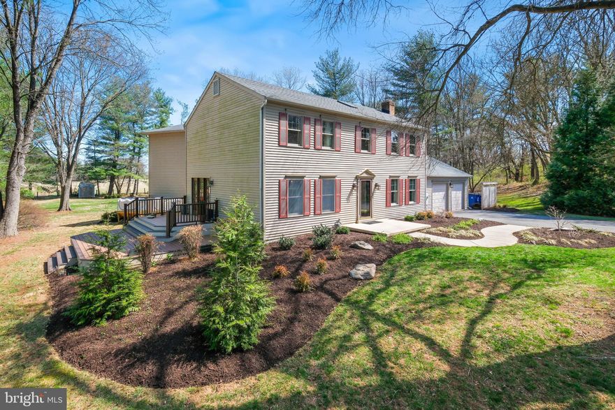 Nestled on nearly two acres of private, tree-lined property, this beautifully renovated home offers a perfect blend of elegance, comfort, and tranquility. A bright entryway with skylights (installed in 2021) and a grand staircase set the tone for the inviting interiors.

To the right, a charming study with a cozy wood-burning fireplace (2020) offers the perfect retreat, while the formal dining room, adorned with wainscoting and elegant William Morris wallpaper (2020), creates an ideal space for gatherings.

At the heart of the home is the exquisite English Farmhouse kitchen (2019), featuring custom hardwood cabinetry, quartz countertops, high-end stainless-steel appliances, and a wine bar with storage for 35 bottles. French doors open to a large two-level side deck (2022), bordered by an herb garden—an idyllic spot for morning coffee or evening cocktails.

The family room boasts refinished floors, a wood-burning fireplace (2023), and sweeping views of the neighboring farm and woodlands. French doors open to a second deck, perfect for outdoor dining. A mudroom, pantry/office space, two-car garage, and half bath complete the main level.

Upstairs, four well-appointed bedrooms offer comfort and privacy. The original wood floors, recently replaced, remain in pristine condition. The front primary suite includes a walk-in closet, an additional built-in closet, and an en-suite shower—an excellent option for an in-law suite or private retreat. Two standard bedrooms, connected by a pocket door, offer a flexible layout. Nearby, a full bathroom with a whirlpool tub and a spacious laundry room—equipped with a countertop, shelving unit, and extra storage—provide everyday convenience.

A sunlit hallway with a built-in bookcase leads to the primary suite addition, where a bright yoga room is perfect for streaming classes. The expansive primary suite features a large walk-in closet and a spa-like bath with dual vanities, a freestanding soaking tub, and an extra-large walk-in shower—all surrounded by serene views of the yard and countryside.

The lower level is designed for versatility, with climate-controlled finished, semi-finished, and unfinished spaces. The finished area serves as a gym with rubber flooring and a wall-mounted TV, while the semi-finished section includes a professional-grade dog grooming station, built-in shelving, and a large workbench. The unfinished space offers extensive storage and houses mechanical systems.

The property offers a private sanctuary surrounded on three sides by mature trees, ensuring both beauty and seclusion. Outdoor highlights include a firepit area for evening relaxation and a cedar-walled garden (2022) with four large, raised beds—ideal for growing fruits and vegetables.

The true showpiece of the property is the heated, in-ground saline pool, complete with an automatic cover and a stunning flagstone deck (replaced in 2019). Adjacent, a spacious patio accommodates multiple grills and an outdoor dining area, creating an entertainer’s dream setting.
This exceptional home seamlessly blends elegance, comfort, and privacy in a breathtaking setting.

Seamlessly blending grandeur, comfort, and modern convenience, this remarkable estate is a rare offering in one of the area’s most coveted locations.