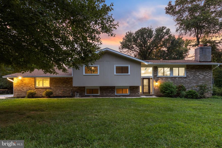 Gorgeous fully renovated 4 bedroom , 3 full bath home in Woodcrest! Open kitchen with white cabinets, quartz counters, stainless steel appliances, large kitchen island with seating for four. Cathedral ceilings with skylights, luxury vinyl flooring, and wood burning fireplace. Dining area with sliders to sun room.  Primary bedroom with en-suite bath with stand-up shower. Two additional bedrooms and hall bath with tub/shower. Huge walk-out lower level family room with second fireplace, fourth bedroom and additional full bath. Spacious laundry room and two car garage. Lower level patio and flat back yard...great for entertaining! This home is beautiful!