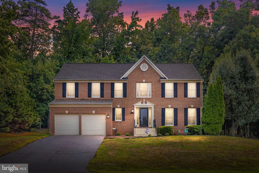 Welcome Home!  Situated on .46 acres, this 4-bedroom, 3.5 bath modern classic brick front colonial home is located on a private cul-de-sac and is not to be missed!  When you enter the home, you are greeted by a large open foyer that showcases a 2-story ceiling and beautiful hardwood floors.  The living room sits at the front of the house and features impressive floor to ceiling picture windows that allow for wonderful natural light. The dining room, an extension of the living room, is generous in size and features crown molding along with traditional custom wainscoting.  The updated eat-in kitchen boasts white cabinets with modern hardware, stainless steel appliances, upgraded granite countertops, glass tile backsplash, an island, and a pantry!  The kitchen island allows for additional informal seating plus extra storage and counter space and showcases glass pendant lighting overhead. The eat-in area, off the kitchen, flows right into the family room and opens to the backyard deck!  The family room features a gas fireplace and with the open floor plan from the kitchen it lends itself as a great area for entertaining and a welcoming gathering space. From the eat-in kitchen enjoy direct access to the backyard and the bi-level deck!  The full upper deck has great space for a dining set and grill; while the lower deck is perfect for additional seating.  The primary bedroom is a true suite that is lavish in size and features a cathedral ceiling and two (2) walk-in closets. The full primary bathroom shines with its separate soaking tub and shower, modern fixtures and lighting and double vanity with significant cabinet storage.  All 4 bedrooms have ceiling fans!  The finished basement features a recreation or 2nd family room, the 3rd full bathroom, a storage area and a bonus room which can be used as an office, guest area, workout area, studio, etc.   From the basement, you have direct access to the fenced in backyard that backs to trees and offers privacy and tranquility!   
NEWER Roof, HVAC System, Heat Pump, Hot Water Heater, Sump Pump, House Generator, Shed and more!  Conveniently located near shopping, I-95 and more!  This home is a must see!