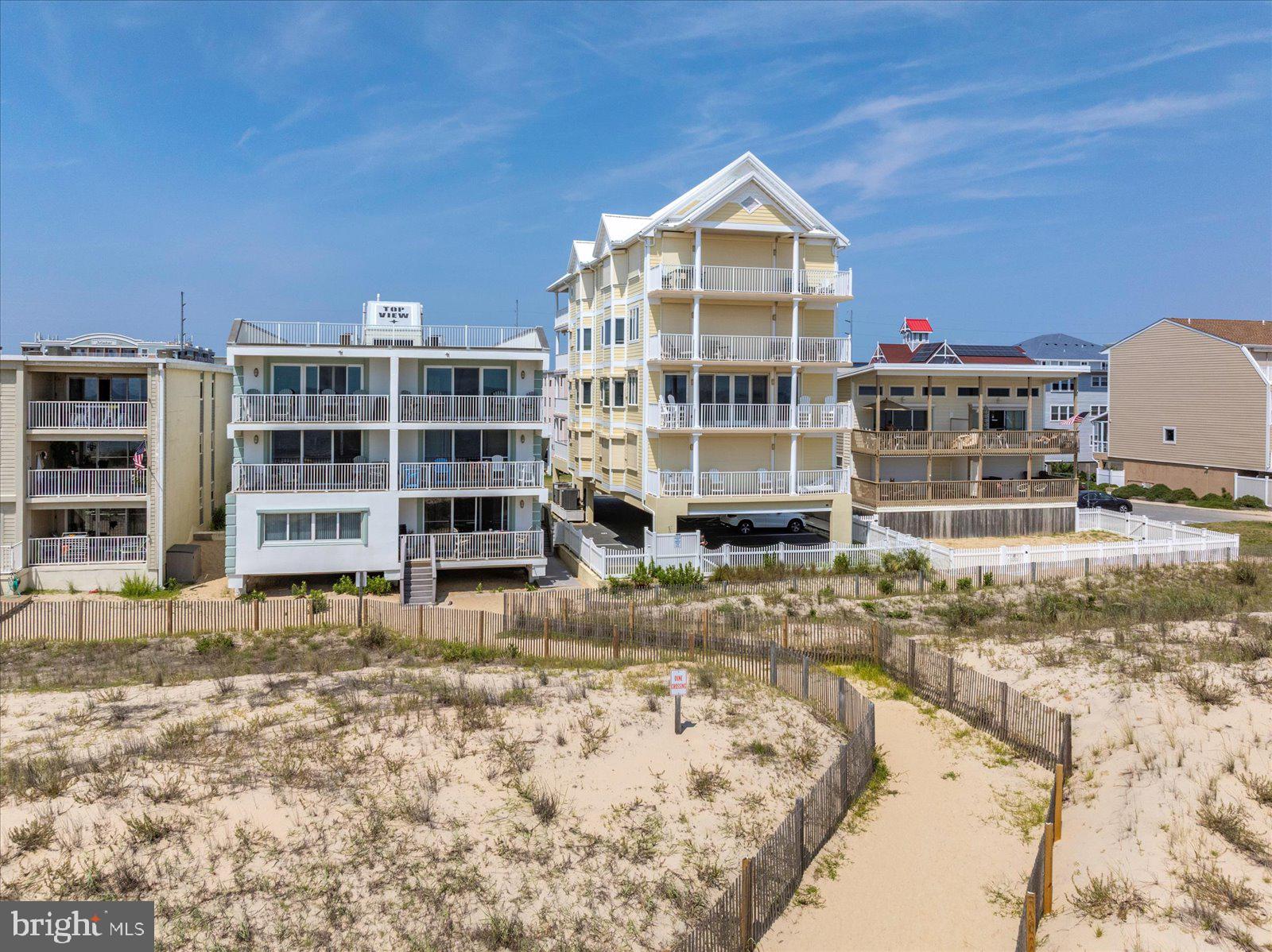 Unparalleled Luxury on the Oceanfront! Welcome to Sunrise Beach, a premier oceanfront destination offering the epitome of coastal elegance. This exceptional 3-bedroom, 3-bath condominium occupies the entire second floor of an exclusive 4-unit building, where privacy, security, and spectacular views define the experience. From the moment you arrive, a secure private elevator opens directly into your foyer. Step inside and be captivated by over 35 feet of unobstructed glass showcasing breathtaking panoramic views of the ocean. Floor-to-ceiling windows line the entire oceanfront of the residence, immersing you in the sights and sounds of the Atlantic, while additional north and south-facing windows offer sweeping vistas up and down the beach. The oceanfront great room is one of the largest in Ocean City, featuring a cozy gas fireplace, elegant sitting area, and seamless flow into the dining and kitchen spaces—perfect for both everyday living and stylish entertaining. The gourmet kitchen is a chef’s dream, appointed with Wolf and Sub-Zero appliances, including two refrigerator drawers, granite countertops, custom cabinetry, soft-close drawers, tile backsplash, tray ceiling, pantry, and counter seating, all illuminated by a sunny window over the sink. The spacious primary suite offers a peaceful retreat with ocean views, a large walk-in closet, and a spa-style bath with Jacuzzi tub, walk-in shower, and custom ceramic tile. Each guest bedroom has its own private en-suite bath, with the third bath doubling as a convenient powder room for visitors. With over 2,000 square feet of thoughtfully designed living space, this residence is filled with upscale details, including electric storm shutters and blinds, recessed lighting, crown molding, wainscoting, and large-format ceramic tile. A separate laundry room with sink, storage cabinets, and full-size washer and dryer adds everyday convenience. Step onto your expansive oceanfront balcony and enjoy coffee at sunrise or simply relax and take in the ever-changing sights and sounds of the ocean and beach. Assigned covered parking provides ease of access, and the adjacent walkway allows you to step directly onto the sand. Sunrise Beach is more than a home—it’s a rare coastal sanctuary that must be seen to be believed. Professionally managed with a recently replaced roof, entire building plus balconies recently painted, and an up to date reserve study make this condominium even more desirable. Whether as a luxurious primary residence or an elite second home, this 2nd floor unit offers a one-of-a-kind lifestyle in one of Ocean City’s most exclusive settings.