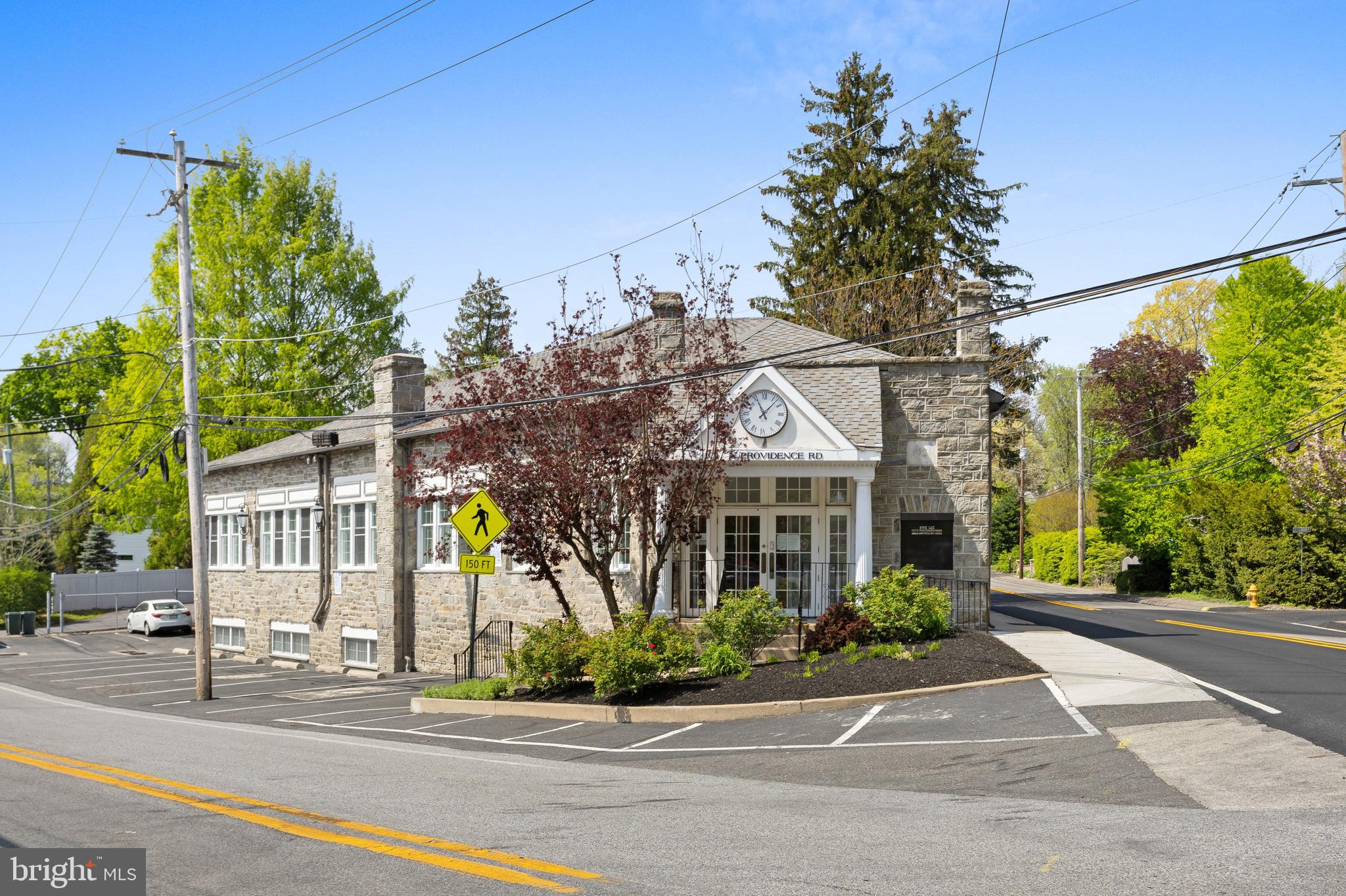 Own an iconic slice of property in Wallingford! Close to Media. This 1921 stone and steel building has exceptional visibility and two-street frontage, making for a great investment or owner-occupied office space. The building boasts abundant natural light, on-site parking for 15 with a small outside eating area, and mature trees. Conveniently located near Media Borough and the Blue Route, next to a Septa bus 118 stop and near Septa R-3 Commuter Rail Station in Wallingford. This approximately 6100 square foot office building features 10 offices on the ground floor, four cubicles, reception area, baths, and coffee station. An 11th office overlooks the main floor. The lower level includes a large conference room, gym, 2 locker rooms, kitchenette, laboratory and storage. New HVAC in 2023 and French drain installed recently. Currently under lease to an engineering firm which will stay until at least Dec 2024, with a lease termination date of June 2025. Come make this unique and useful space yours!