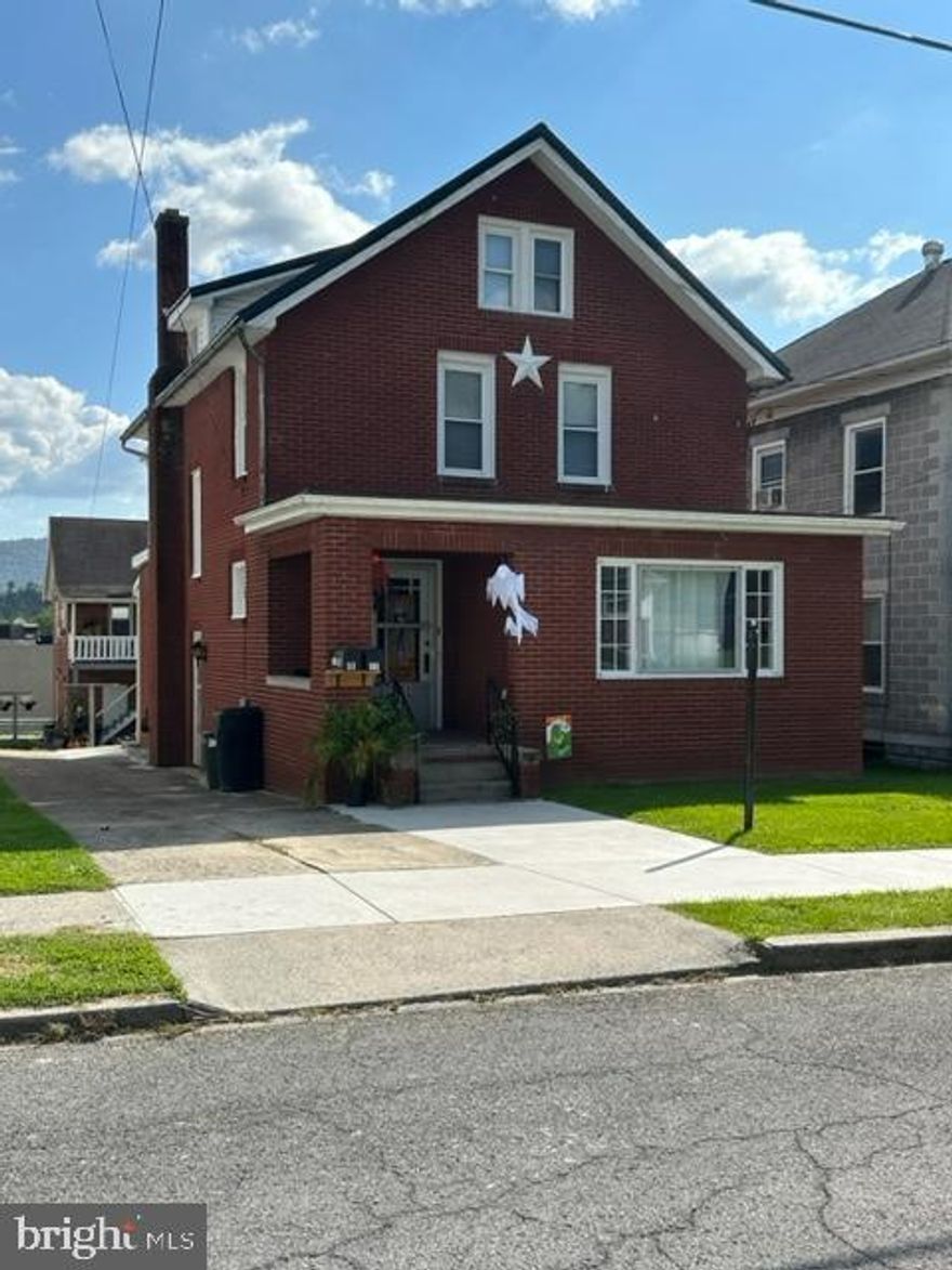 Beautiful brick home with  3 bedrooms, 2 full baths in the main house.  Real wood flooring beautify this very charming home.  There is a 2 bedroom 1 bath unit over the 3 car garage.   Both units have tenants on 1 year leases.   Both units have been completely painted and upgraded, newer windows, etc.  The attic in the main house was done over and being used as a 4th bedroom.   The garage units bathroom was enlarged. 
There is a driveway for off street parking.  This is a rare investment opportunity for a beautiful home with  extra income from the garage unit.