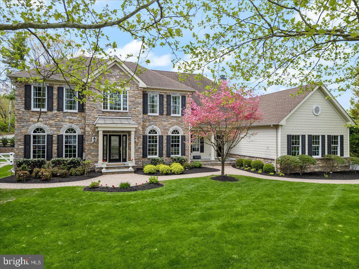 Experience refined living in this stunning property—the largest floor plan in Westtown Chase—boasting 5 bedrooms, 5.5 baths, and a spacious three-car garage. Thoughtfully updated with custom designer finishes and sophisticated touches throughout, this stately center hall Colonial offers space, elegance, and function in one of West Chester’s most sought-after communities.
Step into the grand two-story foyer featuring a curved oak staircase and custom millwork that continues throughout the main level. The formal living and dining rooms showcase new designer lighting, crown molding, fresh designer paint, and upgraded recessed LED lighting. The spacious family room has been enhanced with a coffered ceiling, a custom fireplace mantel, and added woodwork—creating an ideal gathering space anchored in warmth and style.
The kitchen blends form and function with granite countertops, a large center island, ample cabinetry, and recessed lighting. The adjacent breakfast room, featuring a cozy gas fireplace, opens through French doors to a truly spectacular outdoor living space.
Out back, your private retreat awaits—an expansive paver patio lined by mature trees and fully fenced for seclusion and serenity. The backyard features a sparkling pool and spa combo with a built-in slide, a custom firepit, and plenty of room for lounging or entertaining. Whether you're hosting a summer party or enjoying a quiet evening under the stars, this outdoor space delivers the ultimate blend of comfort, fun, and privacy.
Upstairs, the luxurious primary suite offers a tray ceiling, a separate sitting area, and a spa-like bath with double vanities, soaking tub, and oversized double shower. Three additional en-suite bedrooms provide generous accommodations for guests or family.
The finished walkout lower level extends your living space with a full bedroom, bath, kitchenette, gas fireplace, home gym, and entertainment area—plus plenty of storage. Recent updates include new flooring, cabinetry re-staining, and drainage enhancements for lasting peace of mind.
Beautifully landscaped and located in the award-winning West Chester School District, with easy access to shopping, dining, and major roadways, this exceptional home offers luxurious living both indoors and out.
