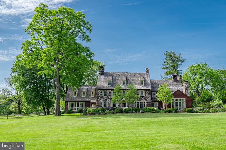 Sprawling across 18+ acres of farmland and bordering the Natural Lands Trust, there are 10 structures that comprise 404 S Swedesford Road. A country gate opens to a quarter-mile-long driveway with views of open fields and a pond. Along the woodline, there are 1,000+ trees and shrubs, including 190 ornamental trees that have been planted by the current owners. 

The main house offers elements that date back to 1698 with several additions accomplished since then. Its most recent renovation was designed to maximize surrounding views, create purposeful spaces, and build a kitchen fit for pastry chefs and professionals. 

In the foyer, a powder room is nestled underneath the main staircase. To the right, there is a living room with reclaimed wood floors and a fireplace, a sunroom with french doors overlooking the home’s backyard, and an office with beamed ceilings and another fireplace. On the left side of the foyer, you’ll find a formal dining room that opens to the back patio and an eat-in kitchen with commercial grade appliances, a wood-burning pizza oven, two large islands, and a butler’s pantry. The family room, mudroom, and second half bath sit nearby.

Five spacious bedrooms and four full baths encompass the second and third floors. The primary suite on the second level boasts a fireplace, wood floors, and beamed ceilings. Its ensuite bathroom has a double steam shower, dual marble vanity, built-ins, and a large walk-in closet with a vanity area. For added convenience, there is a second-floor laundry room. Just outside of the main house, sits an in-ground pool and a detached garage.

Follow the path of maple trees to find a stunning farmstead enhanced by the conversations of chickens, cows, and sheep. The pasture blends sycamore, black elms, black gum trees, golden larches, and willow oaks. With red stone, six stalls, and an attached chicken coop, the barn has been meticulously maintained. Moreover, former stables have been converted into a fitness center with a half bathroom.

The silo apartment house accounts for two units with separate entrances. Upstairs, the first apartment has two bedrooms, one bathroom, and a study. Downstairs, the second apartment has one bedroom, one bathroom, and an enclosed porch. Another separate apartment spans three levels with three bedrooms.

An independent office building showcases a renovated kitchen with wine storage, beamed ceilings, and hardwood floors. The solar innovated greenhouse has been divided to feature a growing environment with monitored systems and automated watering, and a prep room with workspace and a custom concrete sink.

Two remaining structures include a storage shed and a large log cabin that is currently being utilized to make soap. It features high beamed ceilings, industrial appliances, and two storage rooms. Located in Montgomery County and part of Upper Gwynedd Township, the premises are still within easy reach of attractions and schools.