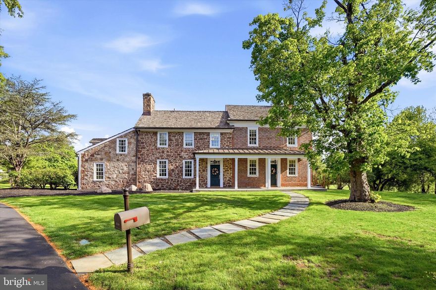 Welcome to the Kirkbride-Palmer Farmhouse at Palmer Farm- a spacious historic property in the heart of the beautifully landscaped Palmer Farm Village- one of Yardley's most desirable communities. The brick portion of the farmhouse was built circa 1753, using bricks that had been brought across the Atlantic as ballast in ships that returned with goods from America, and then the stone portion was added around 1810. In 1987, the 47 acre farm was converted into Palmer Farm Village, an HOA community, with the farmhouse buildings preserved and restored  as the centerpiece.  In 1992, the home was added to the National Register of Historic Places. Originally, the farmhouse was two separate dwellings, but when the current owners purchased the property, they consolidated 559 Palmer Farm Drive and 561 Palmer Farm Drive to create a more spacious home. 

This property is unusual in that it provides the best of historic living, but the benefits of living in one of the few HOA communities where most exterior maintenance is meticulously cared for by the association. The streets, driveways, porches, and paths are cleared of snow in the winter, landscaping of both common areas and on individual lots is included, and exterior painting is taken care of. Residents enjoy amenities like the club house, fitness center, walking and bike trails, playground, tennis and basketball courts, sauna, and pool. The farmhouse itself sits in the most picturesque setting within the community, distanced from the other homes up a private drive, nestled amongst mature flowering trees and overlooking a pond.  The home exhibits the additive quality indicative of early Bucks County architecture, with its Flemish and English brickwork on the original portion of the house, and subsequent stone and shed kitchen additions. Residents enjoy both front and rear porches, as well as a side brick patio and kitchen garden area, with plenty of space to enjoy the peaceful views.  The property also includes a very large barn to the rear of the home, with massive upper and lower garages that EACH can accommodate 2+ cars, with a generous amount of room for storage or a workshop. 

As you enter the home through the rear porch, you are welcomed into a very large living room area with an original fireplace, which also connects to the front porch of the home and is bathed in natural light. This leads into the original portion of the home, which includes a sitting room at the front and a dining room in the middle, each with their own fireplace and original millwork.  The kitchen is at the rear of the home, with plenty of storage and counter space, as well as a large island with seating. The kitchen provides exterior access to the side patio overlooking the pond as well as the kitchen garden area.  A powder room is also conveniently tucked away just off of the kitchen. On the opposite side of the home is a large bedroom (with its own exterior entrance), as well as a full bathroom- perfect for same-floor living or for use as an in-law suite. On the second floor, the owner's suite includes a bedroom, dressing room area, built-in closets and full bathroom.  There are an additional 3 bedrooms and 2 full bathrooms on this floor, with beautiful random-width heart pine flooring, as well as a laundry room.  Since this home was consolidated into one from two dwellings, it has an usual amount of space for such a historic home, allowing residents to enjoy the historic character without compromising on modern conveniences.  The two portions of the home also have their own staircases, basements, and attic spaces. 

Palmer Farm Village is in an unbeatable location- close to shopping and dining, Core Creek & Tyler State Parks, historic Yardley and Newtown, and Wegmans, and it enjoys easy access to I-95, Route 1, and the PA Turnpike, for those commuting to Philadelphia, Princeton or NYC.  Come see the best of low-maintenance, historic living in beautiful Bucks County!