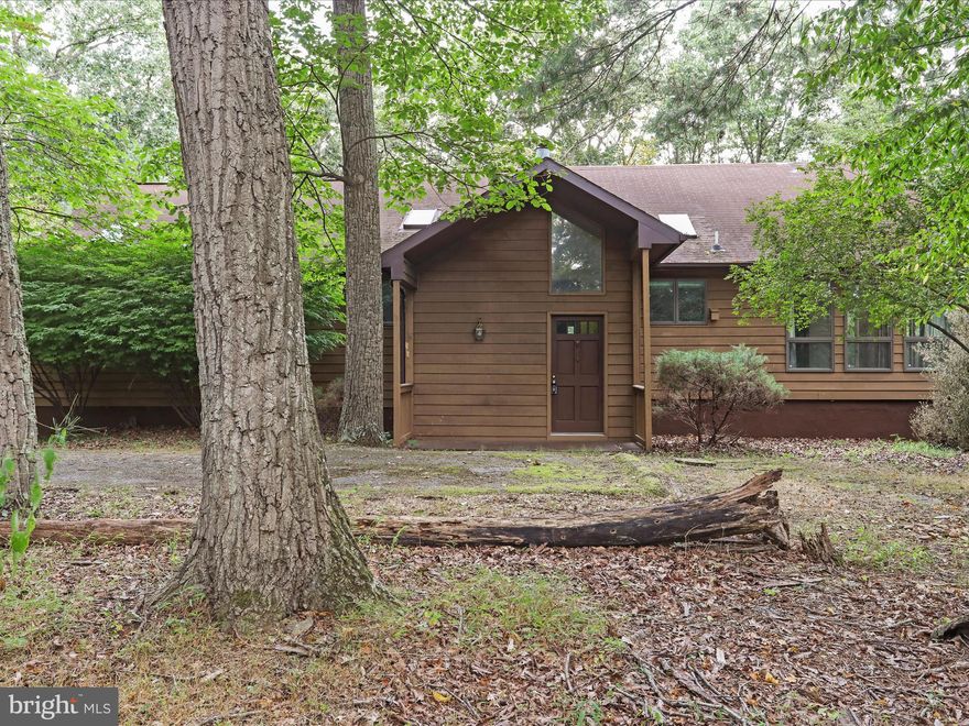 Expansive 4-Acre Opportunity in The Woods
Bring your vision and creativity to this rare find in the coveted community of The Woods.
Situated on just over 4 wooded acres with a Class B membership to The Woods Club available for activation, this 2,000+ sq. ft. home offers massive potential for the right buyer.
Built in 1989 and being sold AS-IS, it retains its original layout and design, with vaulted ceilings in the kitchen, dining, and living rooms, skylights in the kitchen and both bathrooms, and French doors in the dining room, first guest bedroom, and primary bedroom leading to outdoor decks.
The bedrooms are generously sized, including a primary suite with stall shower, garden jetted tub, and custom-ordered ceramic tile. Most windows remain in good condition, and the lot itself is a showstopper - mostly level with mature hardwoods, sunrise views from the front, and mountain glimpses from the back.
The oversized two-car garage includes a massive unfinished bonus space with a separate entrance, already primed for a full bath, kitchenette, and one or two additional bedrooms - ideal for an in-law suite or rental potential.
This home has been cleaned out and deep-cleaned, but it will require a full renovation to reach its full potential. Roof and HVAC are operational but original. All inspections and related contingencies will be for informational purposes only. With its prime location, acreage, and versatile floor plan, this property offers the chance to create a spectacular retreat or income-producing residence in one of the area's most sought-after communities.
A Class B membership to The Woods Club includes access to swimming pools, tennis and pickleball courts, the clubhouse, and more, providing year-round recreation in a scenic mountain setting.