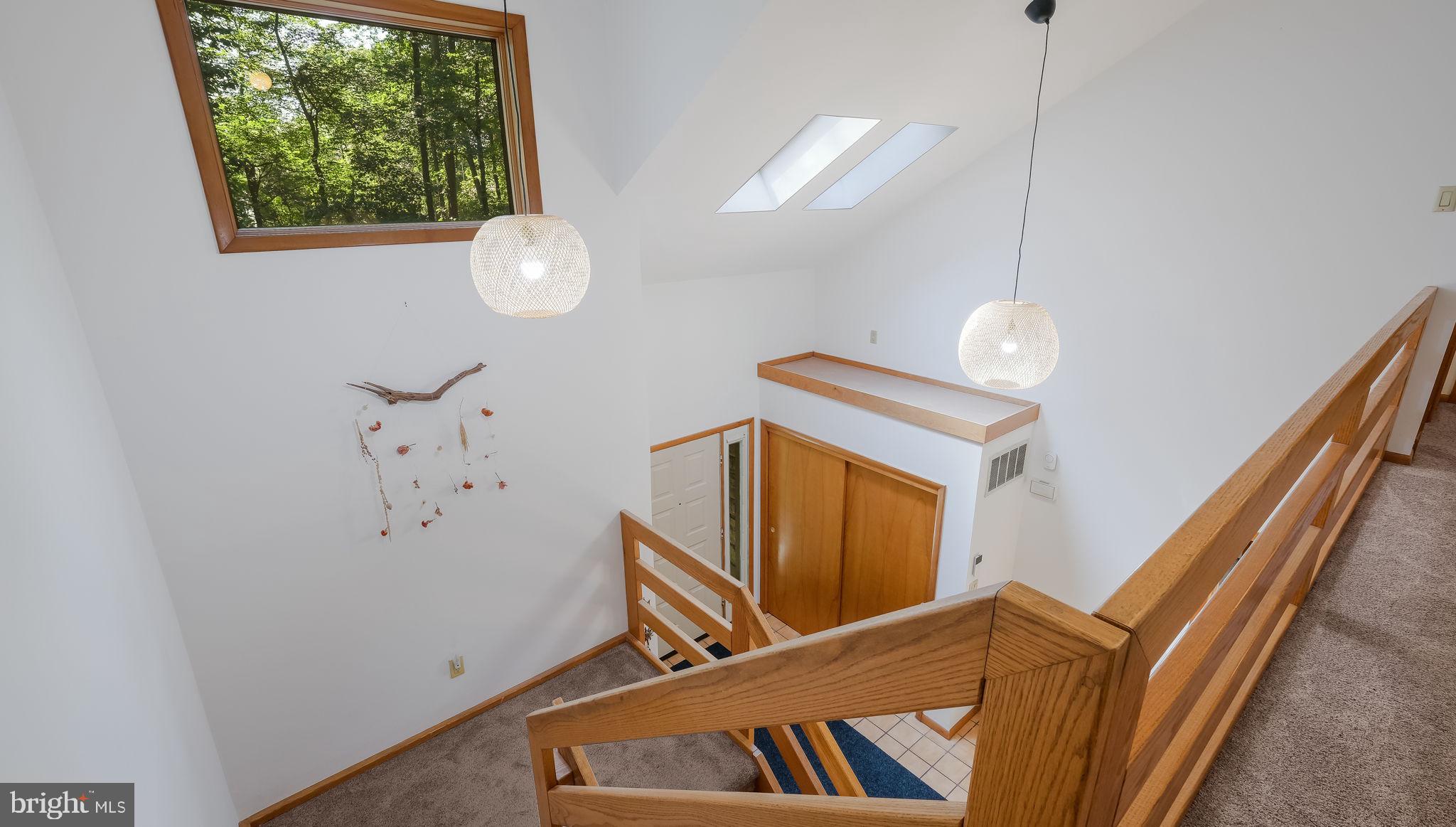 Light-Filled Stone-Front home feels like a Treehouse nestled among the trees on 5+ Acres in Doylestown! Premiere Location within walking distance to Lake Galena and a short drive to Historic Doylestown Borough. Designed for those looking for great space, light, and flexibility, this 4-bedroom, 3.5-bath residence offers a thoughtful layout that can evolve with your needs. The Two-Story Foyer welcomes you with skylights and an Open 3 Story Staircase, filling the space with light. A spacious First-Floor Office or "Bonus" Room offers the perfect opportunity to create a luxurious FIRST-FLOOR primary suite—ideal for MULTIGENERATIONAL living, guests, or your own creative vision. Whether you're working remotely, entertaining, or need extra family space, this home invites you to live---both indoors and out. The heart of this home is the expansive Gourmet Kitchen that opens effortlessly into the inviting Family Room, where a Stone Fireplace with a Wood Burning Stove anchors the space along with charming Built-in Bookshelves. A Bay Window and Sliding Doors invite the outdoors in, while offering easy flow to a BRAND NEW deck—perfect for your morning coffee or yoga. The Kitchen Island is a natural gathering place for family and friends, while a cozy Dining Nook tucked into the Bay Window creates the perfect spot to start or end your days. This Open Kitchen and Family Room space features newer luxury vinyl tile flooring—perfect for busy lives, offering both ease and durability. The Kitchen is both timeless and functional, featuring a classic White Farmhouse sink perfectly positioned beneath a window that overlooks your very own vegetable garden—an inspiring view for any home chef or garden enthusiast. Stainless Steel appliances, a sophisticated custom tile backsplash, and an Oversized Island create a space that's as stylish as it is welcoming! Just off the Kitchen, a thoughtfully designed Mudroom, Washer/Dryer with a Newer FULL bath and WALK-IN Pantry keeps everyday essentials close. The adjacent Dining Room, filled with natural light from a charming BAY window, offers beautiful potential— for a dining room, a studio, a playroom or SECOND home office! Upstairs, the Primary Suite is a true RETREAT, featuring its own private Romeo and Juliet balcony, a flexible Sitting Room (or SECOND walk-in closet), along with a large dedicated Walk-IN closet. The SPA-inspired EN-SUITE bath offers a luxurious escape, with a sweeping WALK-IN shower, Double Vanity, and the Huge SKYLIGHT adds to the "Treehouse" feeling it's like an outdoor shower! Upstairs, you'll find THREE additional well-sized bedrooms and a full bath—perfect for family or guests. The Unfinished Basement offers even more room to grow, whether you envision a home gym or extra storage. Practicality meets ease with a TWO-Car Side-Entry Garage that flows directly into the mudroom—ideal for managing daily comings and goings. Outside is where this property truly shines. Set on 5 peaceful acres, the home offers open yard space for play or gatherings, a thriving vegetable garden, and thoughtfully planted native species that celebrate the natural beauty of Bucks County. Wander through your own back woods, and enjoy nature and privacy yet be minutes to everything Doylestown has to offer!