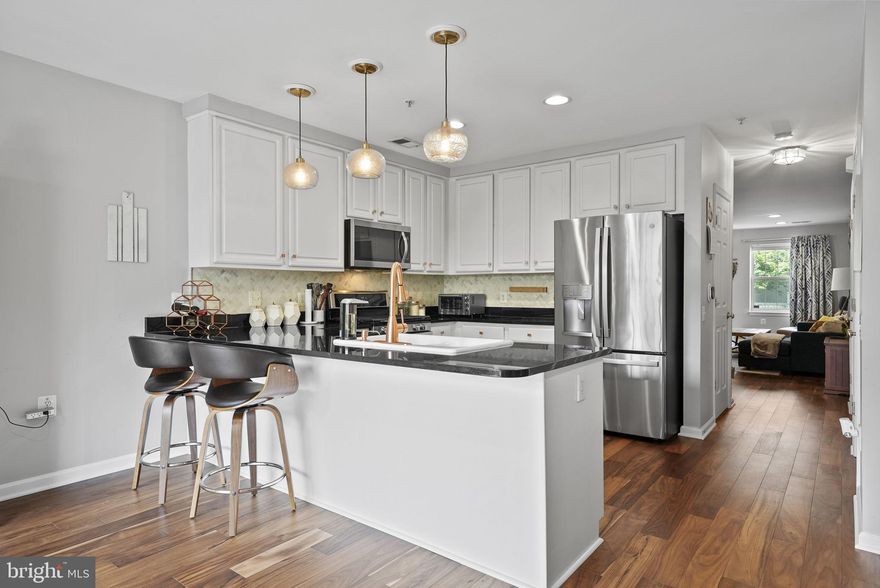 ALL OFFERS DUE on Tuesday 5/21/2024 by 5pm. Welcome to your dream home! This townhouse condo features stunning wide plank hardwood floors throughout the main level. The open concept kitchen is a chef's delight with granite countertops, stainless steel appliances, a marble backsplash, 42-inch cabinets, a pantry, and a breakfast bar. The living area is highlighted by a gas fireplace with a marble surround and hearth, recessed lighting, and modern fixtures.

Enjoy the luxury of tasteful modern bathrooms and a large owner's suite that includes a walk-in closet and an en-suite bathroom with a dual sink vanity, jetted tub, and separate shower. 

Relax on your private patio or take advantage of the community amenities, including a swimming pool and fitness center. Parking is convenient with space for two cars. This prime location is within WALKING DISTANCE to the King St Metro, restaurants, and retail. Plus, it's located in the highly-rated Lyles Crouch School District.