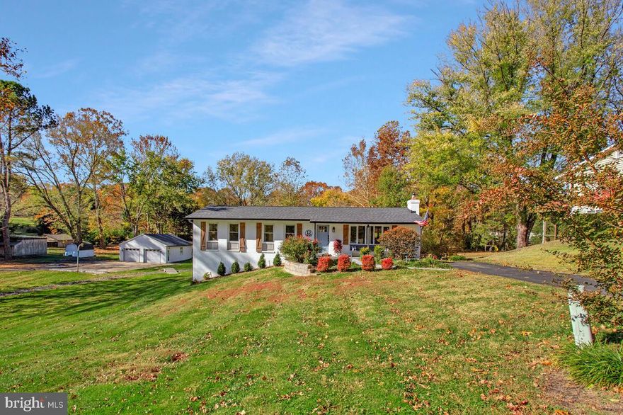 A Diamond in Dunkirk! This updated rambler perfectly blends modern style with timeless craftsman charm. Step into the light-filled family room, where a cozy wood stove, luxury vinyl plank flooring, and custom trim create a warm, inviting atmosphere. The gourmet eat-in kitchen is a true centerpiece, featuring extended quartz countertops, spacious pantry, double wall ovens, stainless steel appliances, a stylish backsplash, and a convenient wet bar with beverage refrigerator. Just off the kitchen, the morning room opens to a maintenance-free deck overlooking the beautifully landscaped backyard. The expansive owner’s suite is a private retreat, complete with a walk-in closet with custom built-ins and a spa-inspired bath boasting double vanities, a spacious walk-in shower, and floor-to-ceiling tile. Direct access to the deck adds everyday convenience. The main level also offers a remodeled full bath and an additional spacious bedroom. The fully finished walk-out basement extends the living space with two more bedrooms, an open recreation room, and a charming laundry room with designer tile and built-in storage. Outside, the freshly painted exterior and wide-open yard create a welcoming first impression, while professional landscaping adds beauty and curb appeal. Two driveways, a oversized detached 27x25 garage, and a versatile entertainment space make this property ideal for gatherings, hobbies, or simply enjoying the outdoors. Peace of mind comes with all major updates already completed—newer roof, HVAC, windows, lighting, and plumbing fixtures throughout. All this in a prime location with easy access to Joint Andrews, Washington D.C., Annapolis, Baltimore, and endless shopping and dining options. This Dunkirk gem offers the perfect blend of comfort, convenience, and style—ready for you to call home.