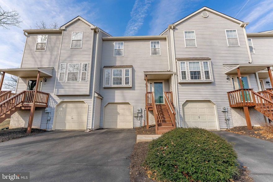 Welcome to 43 Yellowwood Drive, a beautifully updated 3-bedroom, 2-full-bathroom, 2-half-bathroom townhome located in the highly sought-after Brookside neighborhood of Downingtown. This home offers both style and convenience, with a driveway and a one-car garage for added ease. As you step inside, you'll be greeted by the warm, rich hardwood floors that span the entire main level. The inviting foyer leads into the spacious living room, complete with a ceiling light and elegant crown molding. A convenient powder room is located just off the living room for easy access. The chef’s kitchen is the heart of the home, featuring sleek stainless steel appliances and a sliding door that opens onto a wood deck—perfect for entertaining, outdoor dining, or enjoying your morning coffee. The dining room, also on the main level, features a ceiling fan with a light fixture and offers a great space for family meals or gatherings. Upstairs, the primary bedroom is a peaceful retreat with plush carpet flooring, a ceiling fan with a light, and a generous walk-in closet. The en-suite primary bathroom boasts tile floors and a spacious walk-in shower. Two additional bedrooms are perfect for children or guests, both featuring cozy carpet flooring. A full bathroom with tile floors and a tub/shower combo serves these bedrooms. The lower level provides additional space with a laundry area that includes a workbench for added convenience. A second powder room with vinyl flooring is located on this level. The basement also offers access to the garage and houses the home's utilities. Not only does this home provide everything you need for modern living, but it is also ideally located just minutes from local shopping, dining, and grocery stores. With quick access to Horseshoe Pike, commuting is a breeze! Don’t miss the opportunity to make 43 Yellowwood Drive your new home!