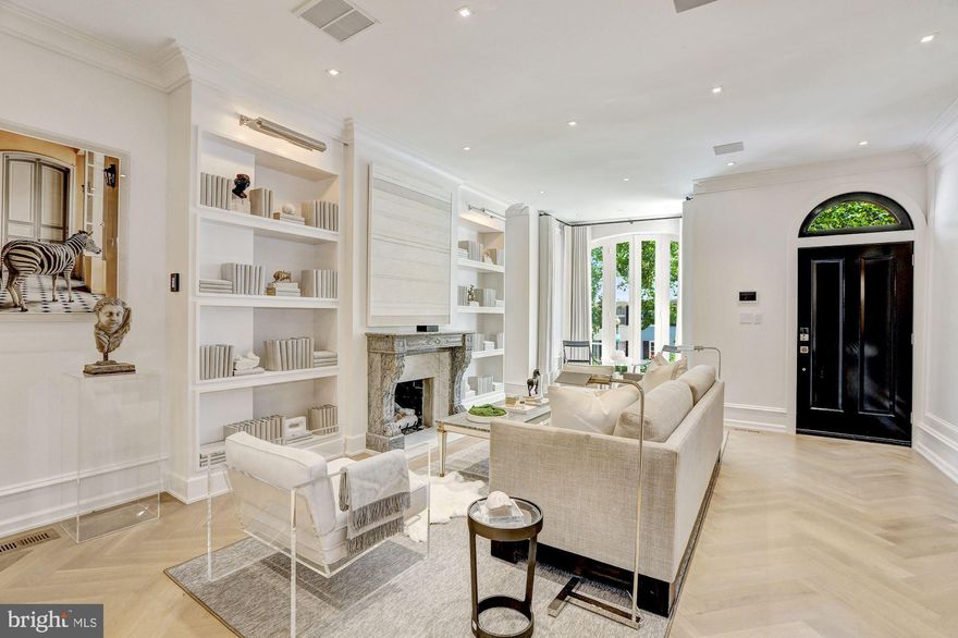 Refined living is redefined in this exquisite new offering from Akseizer Residential! A modern masterpiece on 4 finished levels in the East Village of Georgetown, this in-town estate commands a definitive sense of arrival with signature architectural details and custom millwork throughout. Located in close proximity to M Street, Georgetown Waterfront Park, Dupont Circle, West End, Metro, and more - this true designer showpiece is sculpted to perfection. Beyond the manicured front garden, the grand entrance features premier finishes including herringbone patterned natural wood floors, elaborate custom millwork, 9 9  ceilings, & gourmet kitchen with Quartz white marble-look countertops and top-of-the-line Thermador home-connectivity appliances, plus Waterworks bathrooms throughout. Artisan finishes abound, from the antique French marble fireplace in the living room to the private rear garden with built-in grill, expansive bluestone dining/lounge area, & manicured boxwoods. Savant premium home automation system controls climate, lighting, entertainment, & security from a single intuitive app. Upper Levels boast 9-ft ceilings with 4 Bedrooms and 3 Baths including the ultra-luxe Master Suite w/ double vanity, triple shower, dressing room with custom built-in wardrobes and more. The third level also features a convenient secondary Laundry, marble bar & private balcony overlooking Georgetown. Newly-excavated Lower Level offers 9-ft ceilings, large family room, fourth full bath, marble bar with wine cooler and refrigerators, primary laundry room, as well as private front entrance from P Street. Includes secure single-car parking with automated gate in the rear garden! Too many details to list here!! MUST SEE!