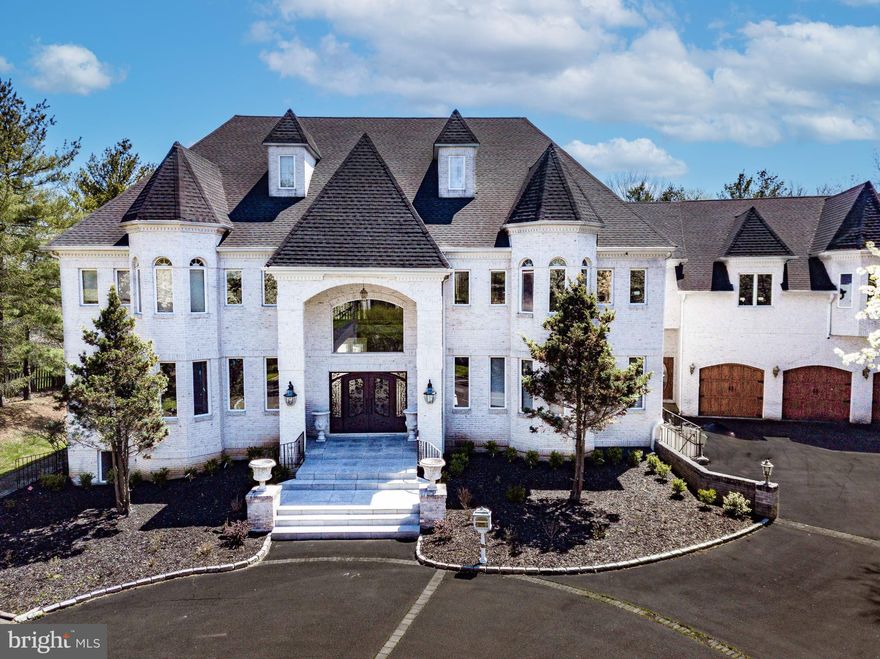 Welcome to 832 Paradise Drive, a palatial French Colonial estate offering nearly 14,000 square feet of meticulously renovated luxury in a private, gated community. Currently undergoing the final stages of a comprehensive top-to-bottom transformation using only the finest materials, this architectural masterpiece sits on more than 1.5 acres of pristine grounds and offers 6+ bedrooms, including several en-suite bedrooms, a rear yard oasis with in-ground pool, and an indoor basketball court. From the moment you arrive at the circular drive adorned with a grand center fountain, you’re greeted by grandeur—Gorgeous French doors open to a dramatic two-story entry with crema marfil marble tile imported from Spain, a sweeping double staircase with copper balusters, and a stunning new chandelier. Inside, regal formal spaces and refined finishes abound, including a 6-foot imported marble fireplace, exotic hardwood floors, detailed millwork, arched hallways, barrel ceilings, and custom moldings. The chef’s kitchen is a true showpiece with soft-close custom cabinetry, imported granite countertops, high-end stainless appliances will include a Viking gas range and Sub-Zero refrigerator, and a spacious center island. Designed for effortless entertaining and everyday luxury, the home includes 3 full wet bars, formal dining with a dual-sided fireplace, and an elegant living room with panoramic views of the lush rear grounds. Multiple bedroom suites are spread across all levels, including a sumptuous primary suite with 2 walk-in closets, a sitting area, fireplace, spa-like bath, and private balcony, and a junior primary suite with spiral staircases to dual closets and a lavish en-suite bath. There is a large Primary Bedroom suite over the 4-car garage that features 3 walk-in closets, 12’ ceilings, and a raised platform fit for a king size bed. A private indoor basketball court with commercial lighting, full bath with steam shower, wine cellar, custom movie theater with step down seating fit for 10-15 viewers, home gym, and billiards room further elevate the lifestyle experience. Outside, enjoy the resort-style in-ground pool with built-in hot tub, waterfall, pool house with full bath featuring steam shower, and WiFi-enabled features, alongside a covered outdoor kitchen and pool cabana ideal for entertaining. All window treatments include drapery and royal adornments. Several architectural elements have been added to the home including columns and corbels. The roof has been replaced along with several doors and windows throughout the home. The property also features a motor court, four-car garage, and caretaker’s quarters. Located just minutes from major highways and conveniences, this turnkey estate offers unmatched grandeur, premier amenities, and a lifestyle of effortless luxury for the most discerning buyer. This home is located in the Hatboro-Horsham School District which features several new/newer elementary schools, and a brand new Keith Valley Middle School set to be completed the summer of 2025.