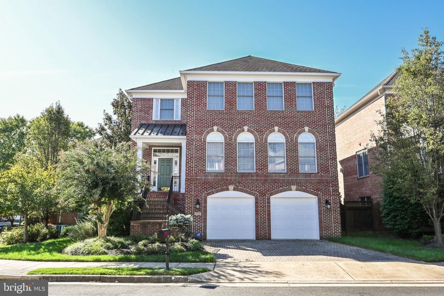 With over $75,000 invested in upgrades, this immaculate executive home in Tysons presents itself on a prime lot offering sweeping views of the expansive park-like common area. Renowned for its superior craftsmanship and proximity to Tysons' contemporary luxury conveniences, the Arden Oaks community is tailored to the most astute homebuyers. The residence showcases a stately four-side brick exterior that seamlessly integrates with a brick paver driveway and front steps, exuding timeless elegance.  Welcoming both family and guests, the metal-seamed roof portico leads into an extended height Foyer, setting the tone for the home's refined atmosphere. The interior features sand-in-place hardwood floors, heavy crown molding, and a refreshed paint palette throughout the Main Level. The Living and Family Rooms effortlessly flow together, complemented by custom built-ins framing the gas fireplace. Expansive triple sliding glass doors, crowned by arched transoms, not only grant access to the rear deck but also bathe the open concept main level in natural light. Completing this inviting space, the breakfast room boasts a new light fixture. The updated kitchen showcases pristine white cabinetry complemented by a contrasting cherry island, exquisite granite countertops, a tasteful tile backsplash, and top-of-the-line stainless steel monogram appliances. Adjacent to the kitchen, you'll find a convenient walk-in pantry, butler’s pantry, and powder room, leading to the formal dining room enclosed by squared columns and detailed with shadow boxing and chair rail moldings.  Ascend the switchback staircase featuring freshly painted white risers and elegant black railings, arriving at the upper level landing. Through the double doors lies the freshly painted Primary Suite, boasting a tray ceiling, crown molding, and two walk-in closets. Recently remodeled in 2023, the primary bath exudes sophistication with split white vanities, Marble-Style quartz countertops, a stunning vessel tub, and sleek frameless shower doors. The luxurious tile flooring seamlessly extends into the shower, adorned with floor-to-ceiling tile, and a captivating hexagon tile shower floor. Two additional bedrooms share a generously sized Hall Bath complete with double vanities, a soaking tub, separate shower, and water closet. The walkout Lower Level recreation room offers twin sliding glass doors, carpeting, crown molding, and a well-appointed wet bar. Full-size windows illuminate the bedroom or gym area, accompanied by a full bath and a two-car garage with storage closet, complete this level.  Outside, the new Trex deck, as well as the patio within the fully fenced backyard, provide serene vistas of the lush 1.43-acre common area. Conveniently situated near commuter routes, the Silver Line Metro at Tysons Corner & Dunn Loring Metro, and the shopping delights of Merrifield's Mosaic District and Tysons Corner, this home offers an unparalleled blend of luxury, convenience, and modern elegance. Call for features sheet, floor plan, or private showing.