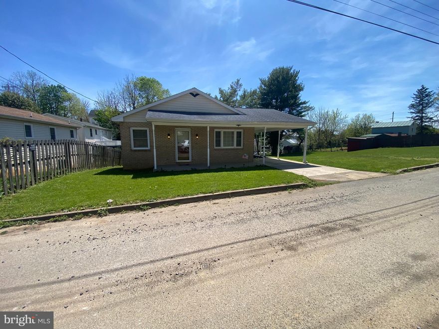 This brick front rancher features 3 bedrooms and 2 full bathrooms and is situated on two full city lots - wow! The main level features a large living room with carpet and ceiling fan light fixture. The living room opens to your dining room. This is a great set up for entertaining! Carpet carries into the dining room and features a ceiling fan fixture. The dining room is conveniently adjacent to the kitchen. Your full kitchen includes easy care laminate flooring, oak cabinetry, laminate countertops, and another ceiling fan. All of the appliances convey. Down the hall you have two generously sized bedrooms featuring carpet and ceiling fans. The primary bedroom measures 11 ft x 13 ft a features lots of natural light, carpet, and ceiling fan. The main level full bath includes a 48 in single bowl vanity, steel tub with ceramic tile surround, and a huge linen closet for tons of storage. The lower level is finished into a large rec room. There is bonus room with vinyl flooring. This could be a den, office, or craft room. The laundry/utility room features concrete floors and houses your laundry machines, updated oil forced hot air furnace with central AC, and updated electric water heater. It also features oak cabinetry and shelving for lots of storage. The lower-level bathroom is quite large, measuring 12 ft x 7 ft. It features a 36 in single bowl vanity with oak base, 3 ft acrylic shower, and a linen closet for lots of storage. The basement walks out into the rear yard. Outside you have a large covered front porch, spacious deck with stairs to the yard and a 10 ft x 29 ft carport. The cherry on top of this lovely home is that the roof has been recently updated. This property has everything you've been looking for. Call to see it today!