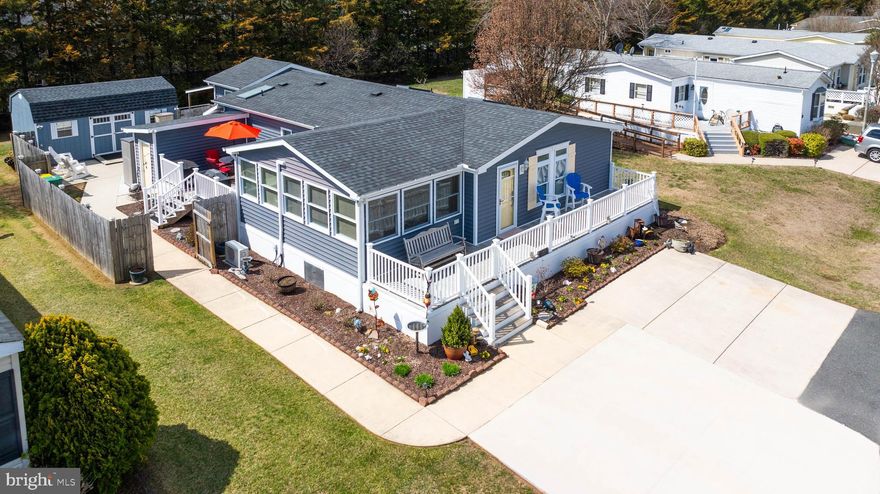 If you are looking for the ordinary then this isn't your new home, but if you are looking for something special you have got to look at this one! I am not sure where to start with this one, but here we go! Outdoor entertainment will be easy because you have 3 options - a wonderful, fenced yard with concrete patio that offers you privacy, there is also the deck off the main bedroom which would be nice for quiet evenings or morning coffee, again you have privacy.  If you would rather see neighbors, there is a nice deck off the family room where you can welcome visitors. Lastly there is the front porch to catch the sun in the morning or watch the evening come outside.  Let’s talk about a few of the details you won't find at other homes in this price range; Out back there is a 12x20 building that is currently being used for a woodshop, it has a mini split to provide heat & air plus full electric, so the options are endless. Then we can talk about the 10x16 building that also has a mini split for heat & air and is currently being used as a stained-glass studio, with its location right outside of the main bedroom you might use it as a work from home space, a walk-in closet, or a craft studio of your own.  There is an attached shed for your storage needs. Hey, there is a home included in this "compound" so let’s talk about it- The current owner replaced the windows, exterior doors, siding, roof, updated the kitchen with new cabinets, countertops, appliances,  updated the primary bathroom with large tiled walk in shower, new vanity & toilet & flooring, all interior doors were placed as well, the family room was a screened in porch and it was built out to be the bright family room.  All the decks were replaced! She added two additional parking spaces so now there are 4.  Plus, she had the old water lines replaced and encapsulated the crawl space which includes a dehumidifier.  This home is located in Aspen Meadows, which is located only about 4 miles from Rehoboth Beach, a short distance from Dewey, Lewes and Bethany Beaches.  Buyers must be Park approved which includes credit & background check & income.  This home is on leased land , which is $840 a month.  This community offers a pool, clubhouse, fitness room and a voluntary HOA that provides the community with social events and communicates with Park management to keep the community a wonderful place to live or vacation.  No short-term rentals are allowed.   Come take a look at this one, you won’t be disappointed.