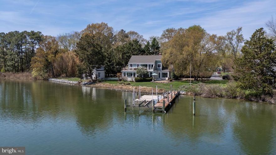 Oxford Cove – A truly rare offering, this extraordinary waterfront property is a study in serenity, privilege, and timeless eastern shore beauty.  Surrounded by sweeping, uninterrupted water views to the south and east, the property captures the beautiful sunrise, immersing you in the everchanging light and rhythm of the tides.
The main residence- graciously scaled with four bedrooms-embraces a refined yet relaxed aesthetic, designed for effortless living and seamless indoor-outdoor flow.  Expansive terrace with a waterside pool, creates an idyllic setting for both quiet reflection and elegant entertaining.
A charming one bedroom guest house/pool house offers a private haven for visitors, while a separate workshop provides space for creativity or collection.  For the avid mariner, the property is exceptionally equipped with a private pier with a boat lift and a floating dock for kayaks and canoes- delivering immediate access to the finest waters of the Chesapeake Bay.
Set in the historic village of Oxford,, one of the Eastern Shore’s most treasured enclaves, “Oxford Cove” offers a rare balance of seclusion and proximity.  Here, life is defined by understated luxury, natural beauty, and the enduring allure of the waterfront.