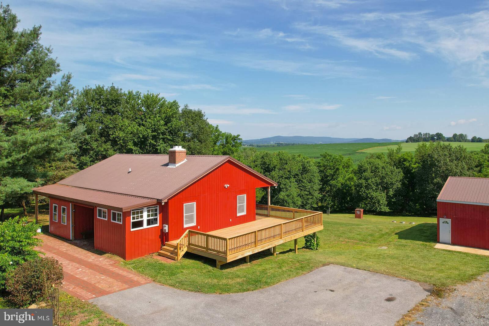 Discover a rare chance to own a home nestled on 3.72 acres of open yet private land near the heart of Middletown. Whether you’re dreaming of starting a homestead, creating a cozy farmette, or simply craving a peaceful place to call home with room to grow, this charming ranch-style property has it all.
Featuring 3 bedrooms, 2.5 baths, a finished basement, this home offers space, comfort, and stunning mountain views from the back balcony. Enjoy the tranquility of the countryside while being just 2 minutes from the heart of town by car.
The property includes a brand new deck, an oversized detached shop with 10 x 10 door clearance, its own HVAC system perfect for a garage, workshop, studio, or business space, storing recreational vehicles, large vehicles, or farming equipment. The updated kitchen features granite countertops and two sinks, making it ideal for gatherings and entertaining. A rustic sliding barn door at the front entrance of the home and the outbuilding adds a touch of charm and can be closed for more privacy.
A small stretch of a neighboring creek flows through the rear left corner of the lot, adding to the natural beauty and serene atmosphere. Stroll along starting at the back wired fence line and walk around to see for yourself; experience the simple, quiet life this home and land has to offer. Come take a look and imagine the future you can build here! No HOA, no city taxes, just space, your potential, and peace. As-is.